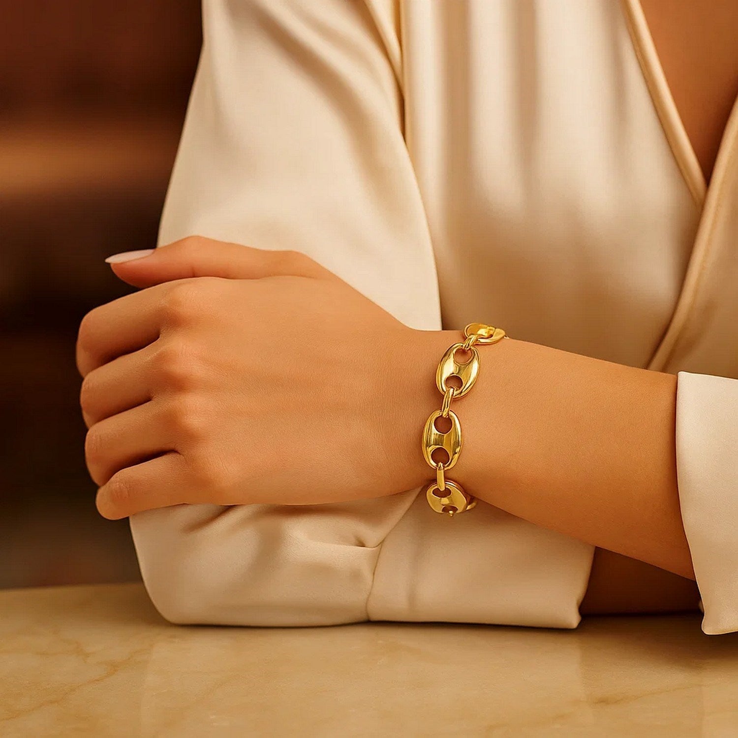 14k yellow gold high polish lite puffed mariner link bracelet on a woman's wrist.