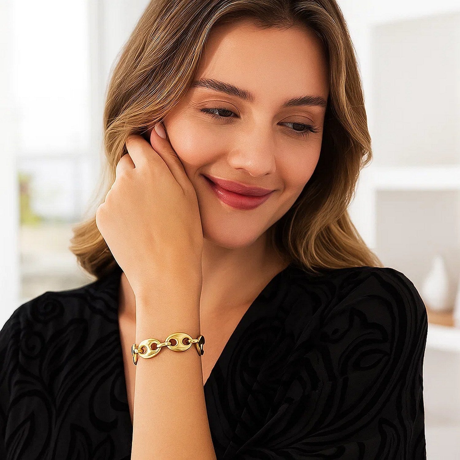 14k yellow gold high polish lite puffed mariner link bracelet on a woman's wrist.