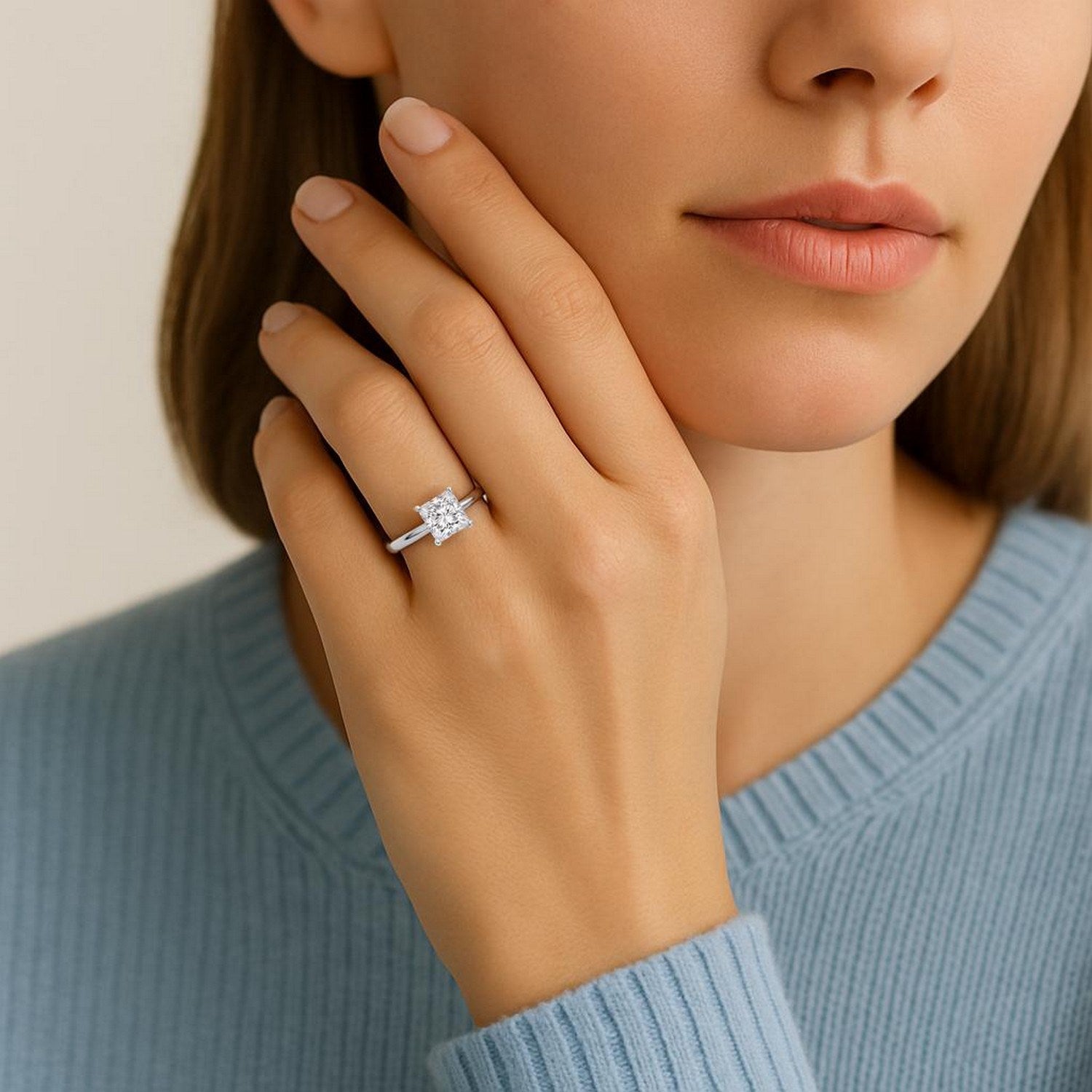 1.50 carat princess lab grown diamond ring in 10K white gold on a woman's finger.