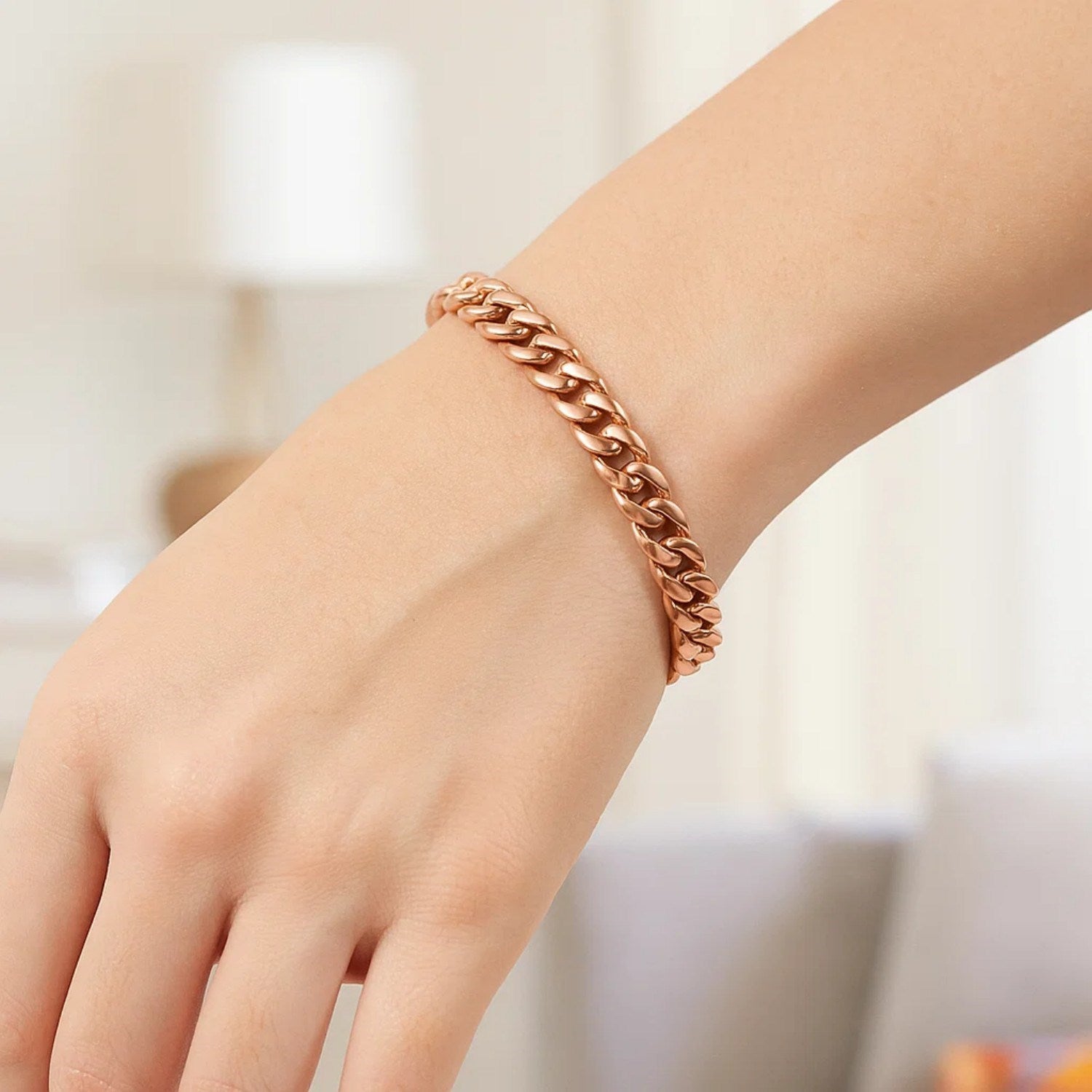 14K rose gold Cuban link bracelet on a person's wrist.