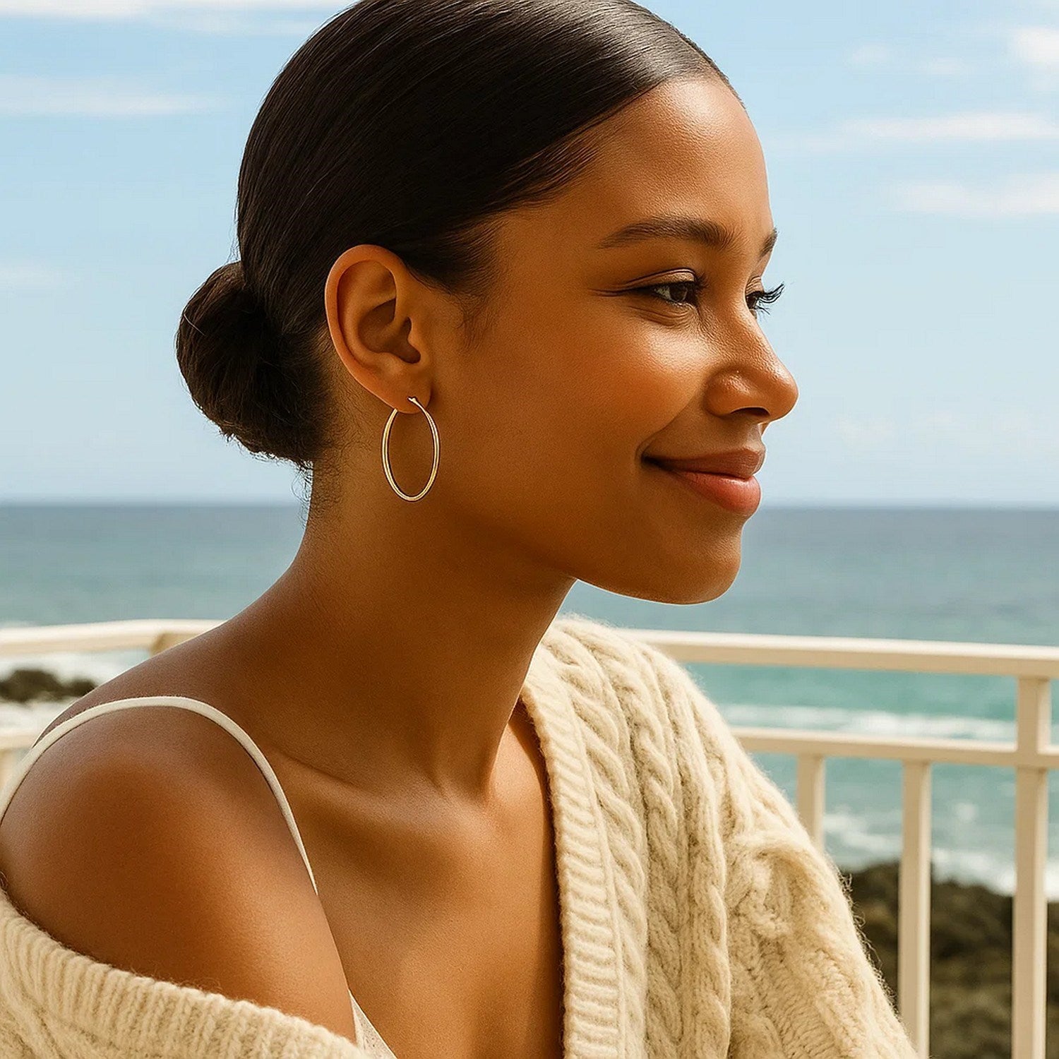 10k yellow gold polished hoop earrings on a woman with her hair in a bun.