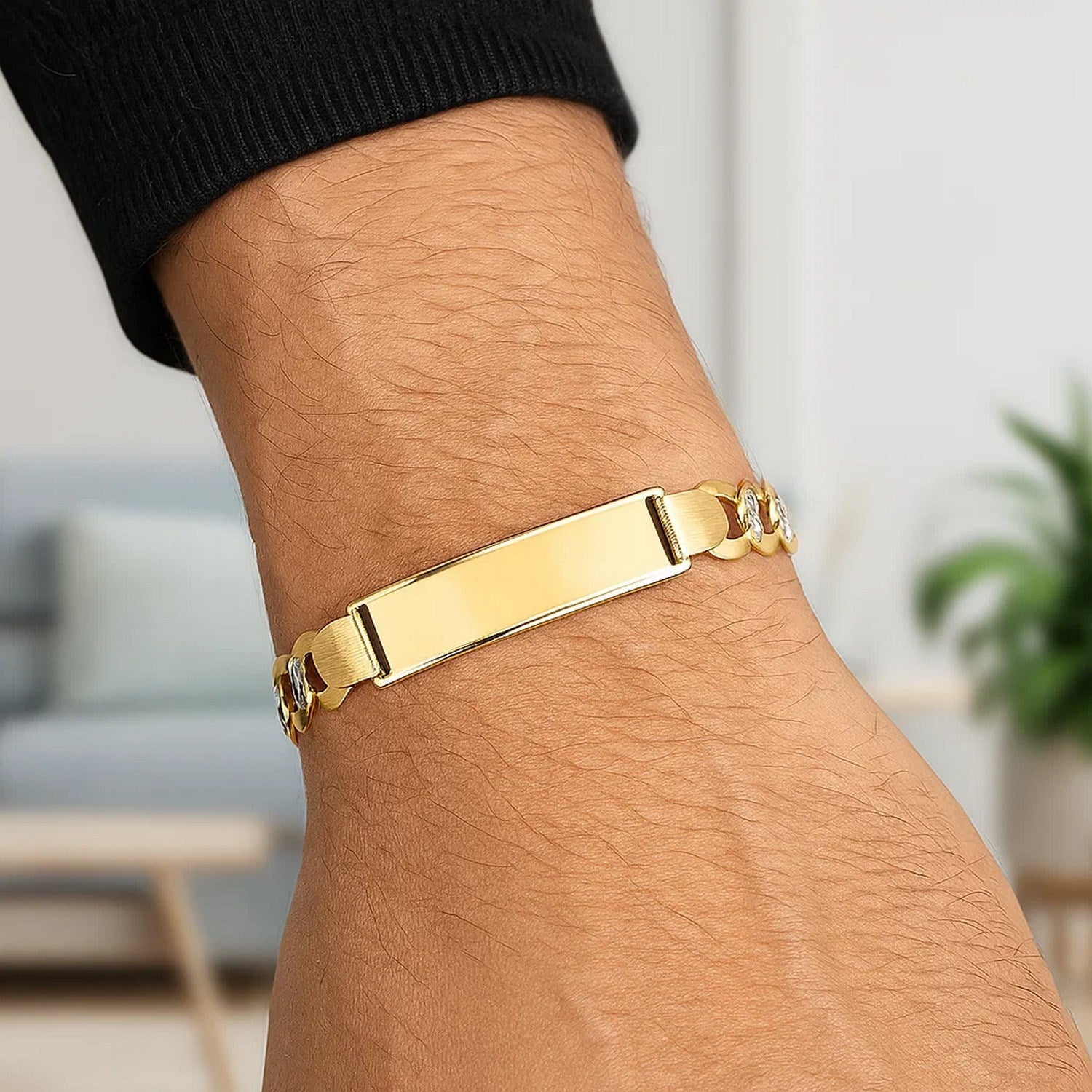 14k yellow gold pave curb ID bracelet with a small diamond on a man's wrist.
