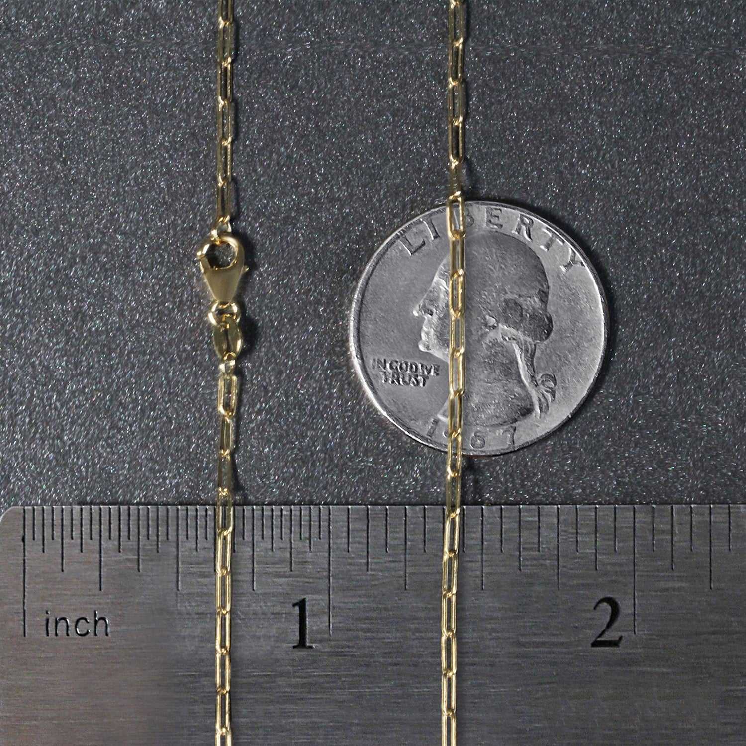 18K yellow gold fine paperclip chain with a lobster clasp, shown with a ruler and coin for scale.