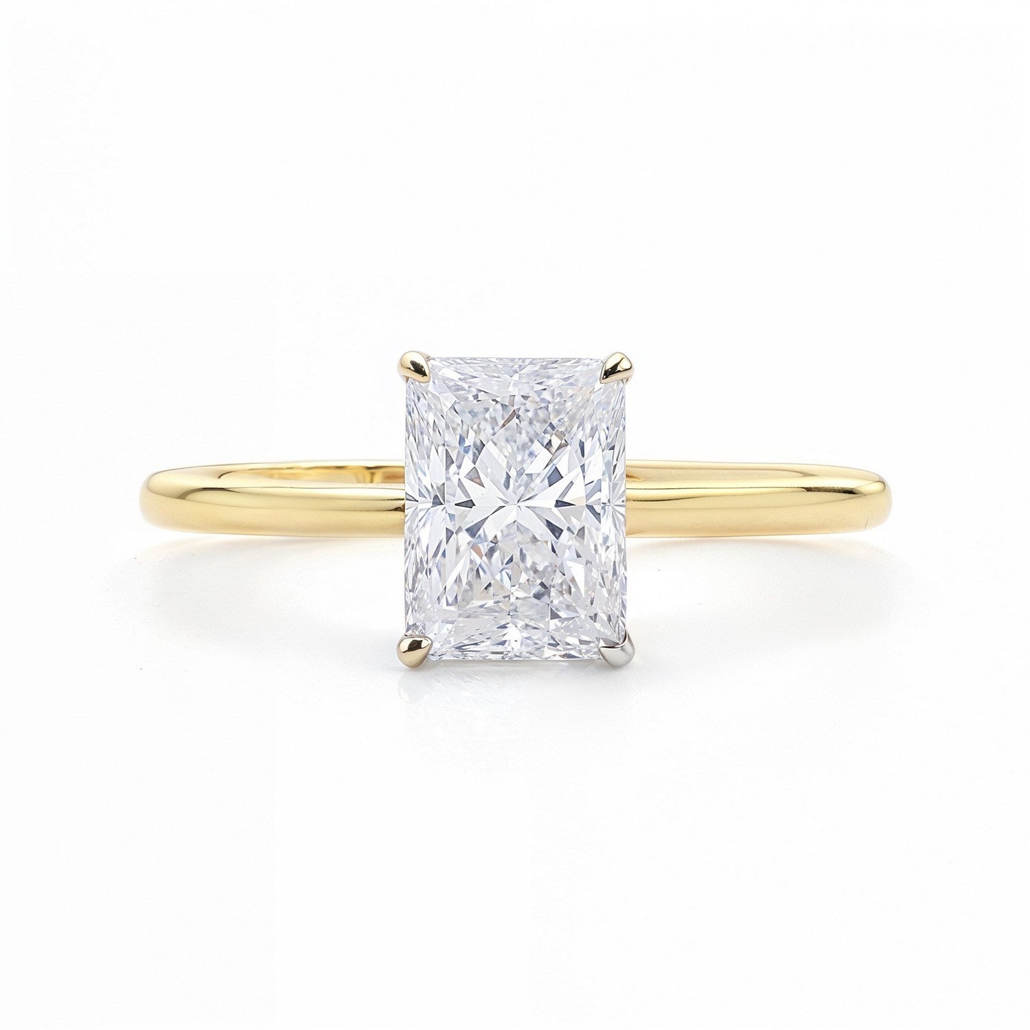 A radiant-cut lab-grown diamond solitaire ring in 14K yellow gold.