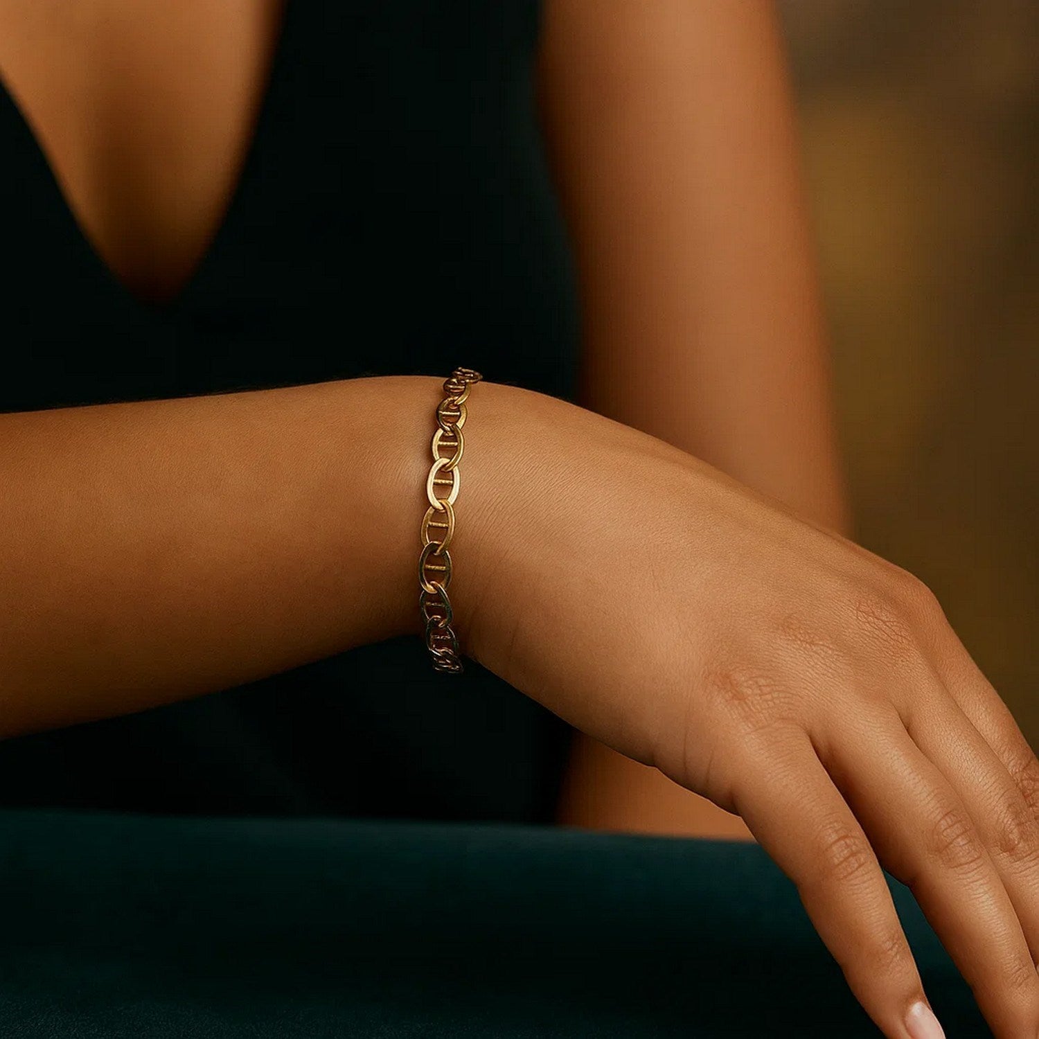 10k yellow gold mariner link bracelet on a woman's wrist.