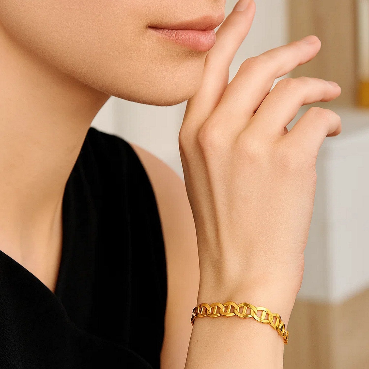 10k yellow gold mariner link bracelet on a model's wrist.