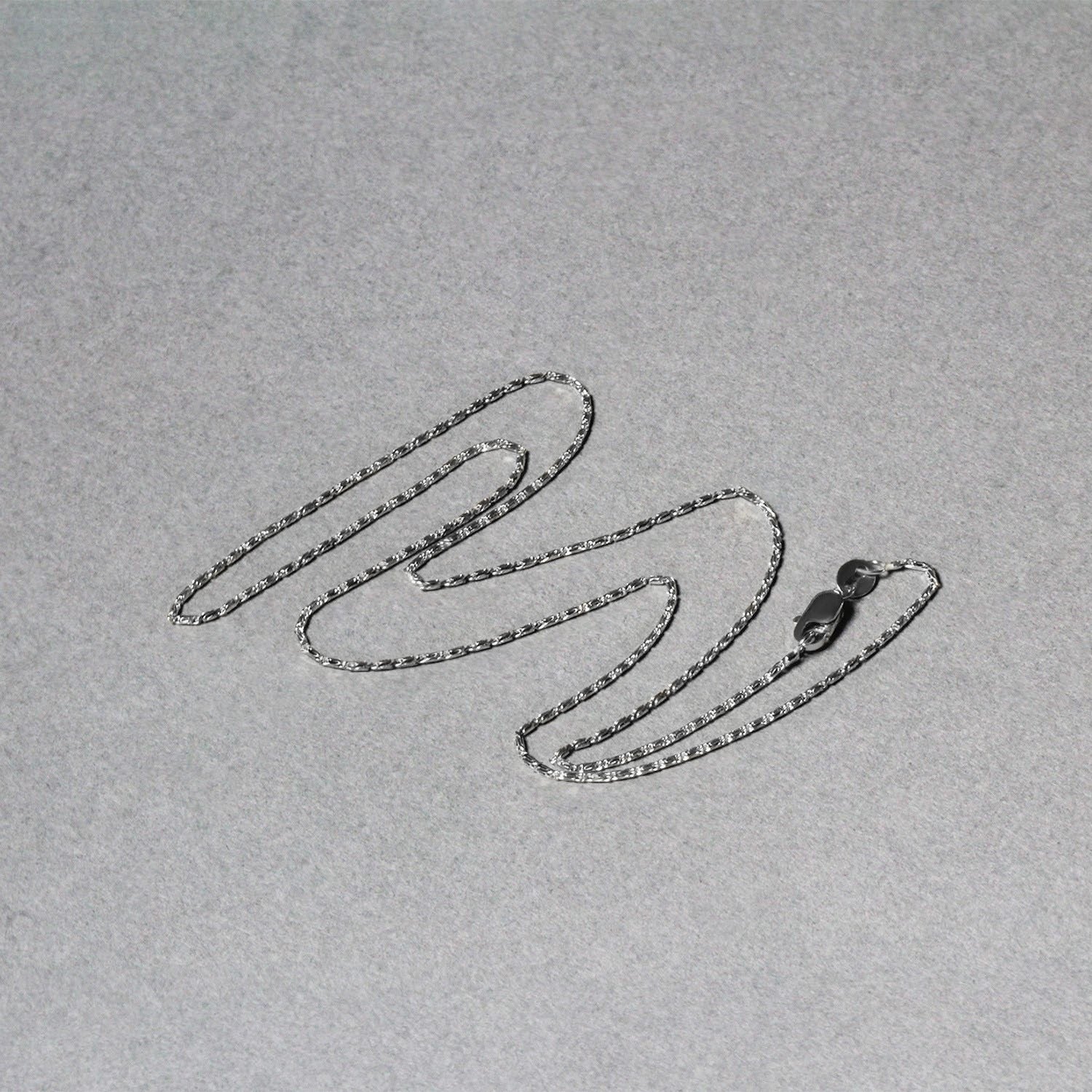 A 14k white gold lumina pendant chain with a lobster clasp.