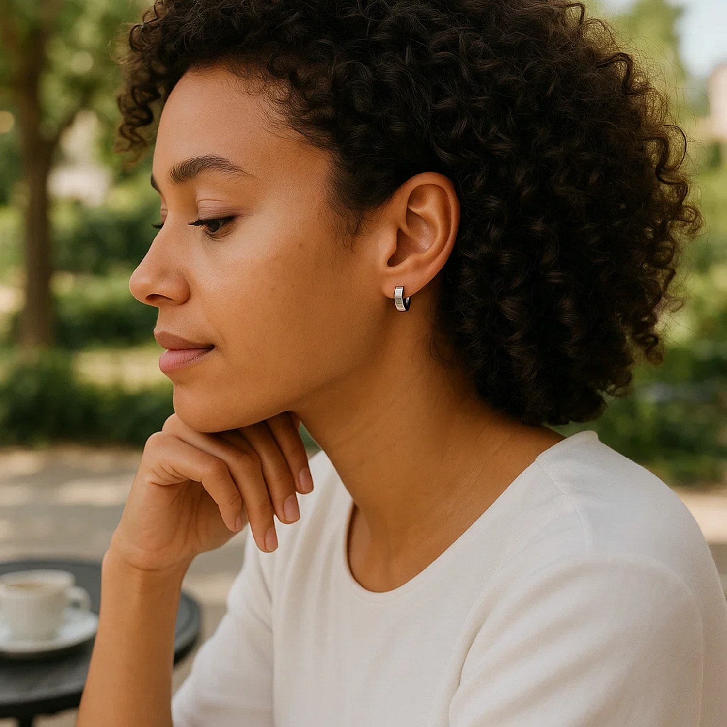 10k white gold snuggable hoop earrings on a woman.