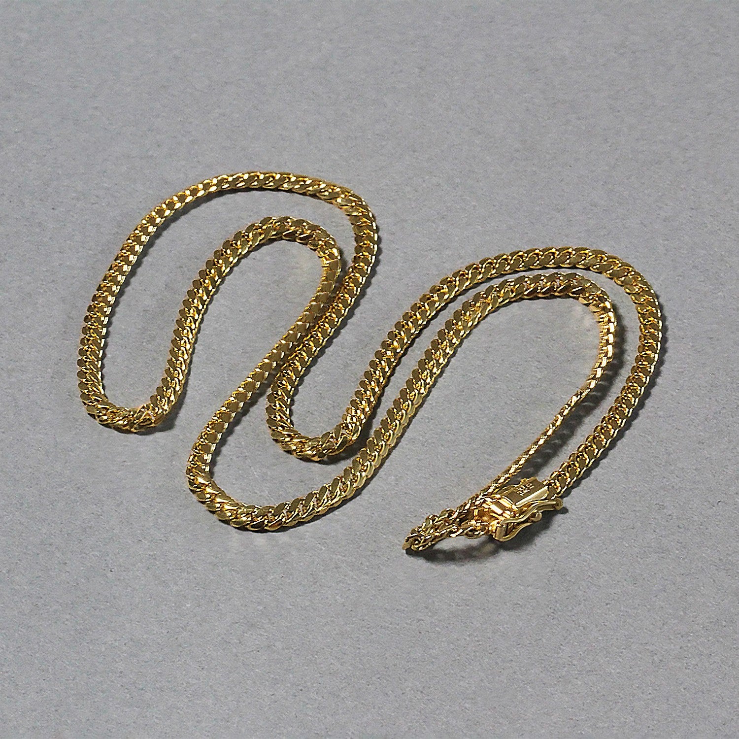 A 10k yellow gold classic solid Miami Cuban chain with a box catch clasp.
