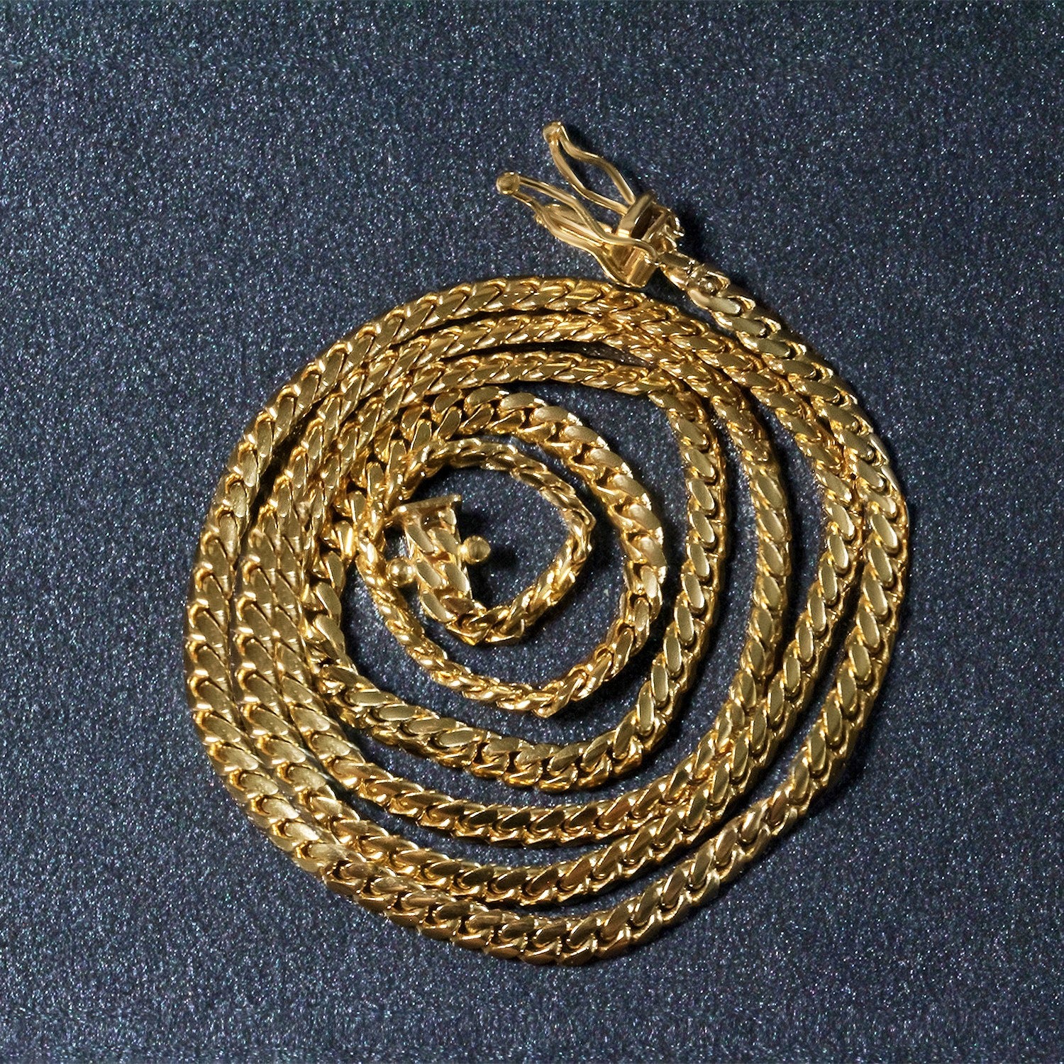 A 10k yellow gold classic solid Miami Cuban chain with a box clasp.