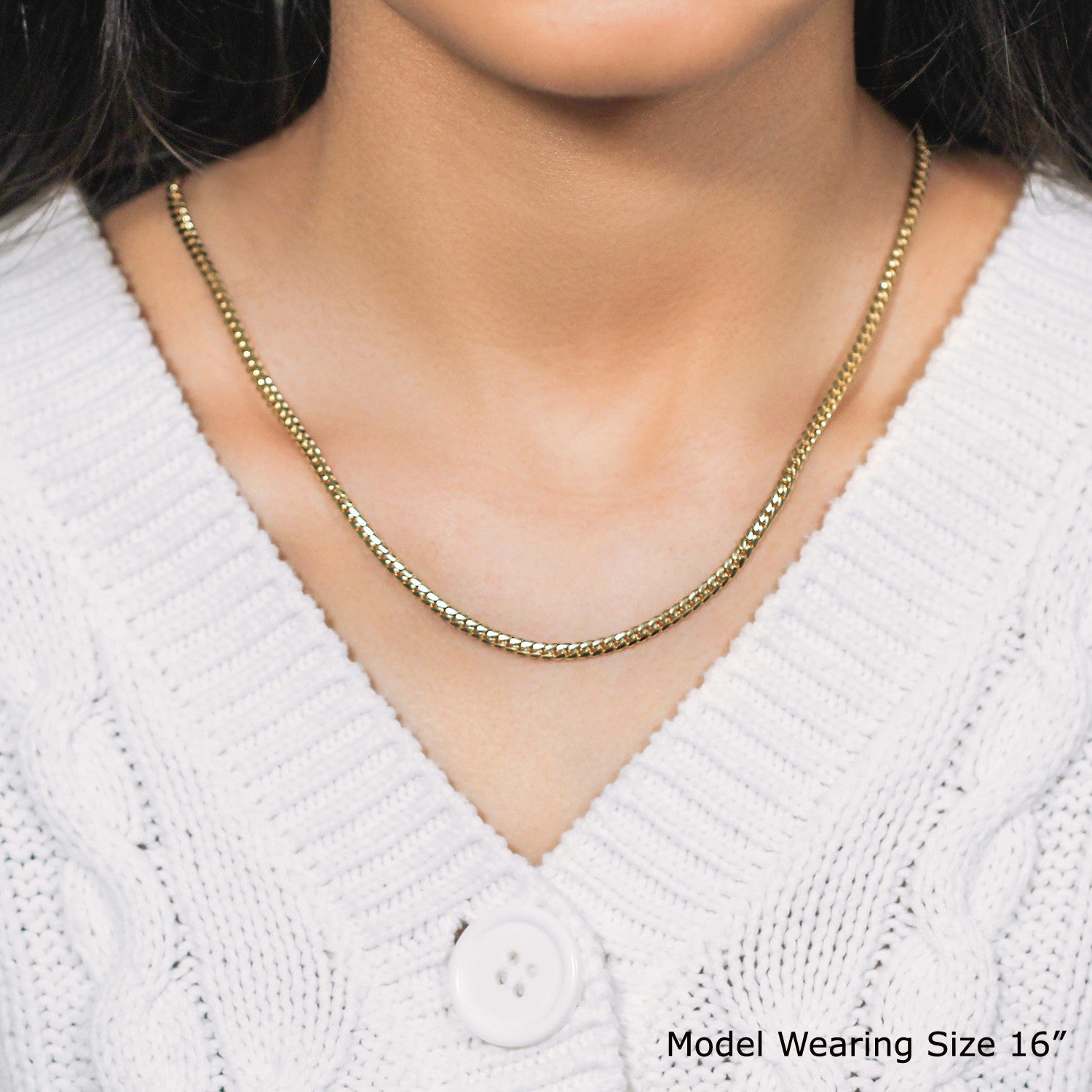 A 10k yellow gold classic solid Miami Cuban chain worn by a model.