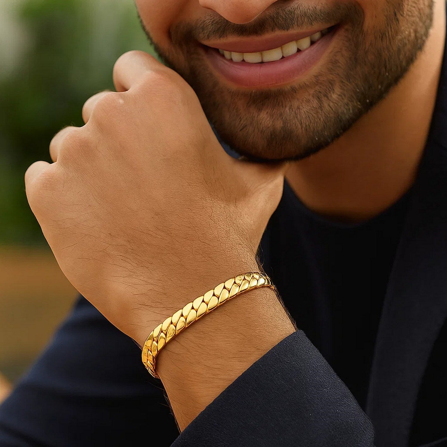 14k yellow gold curb chain bracelet on a man's wrist.