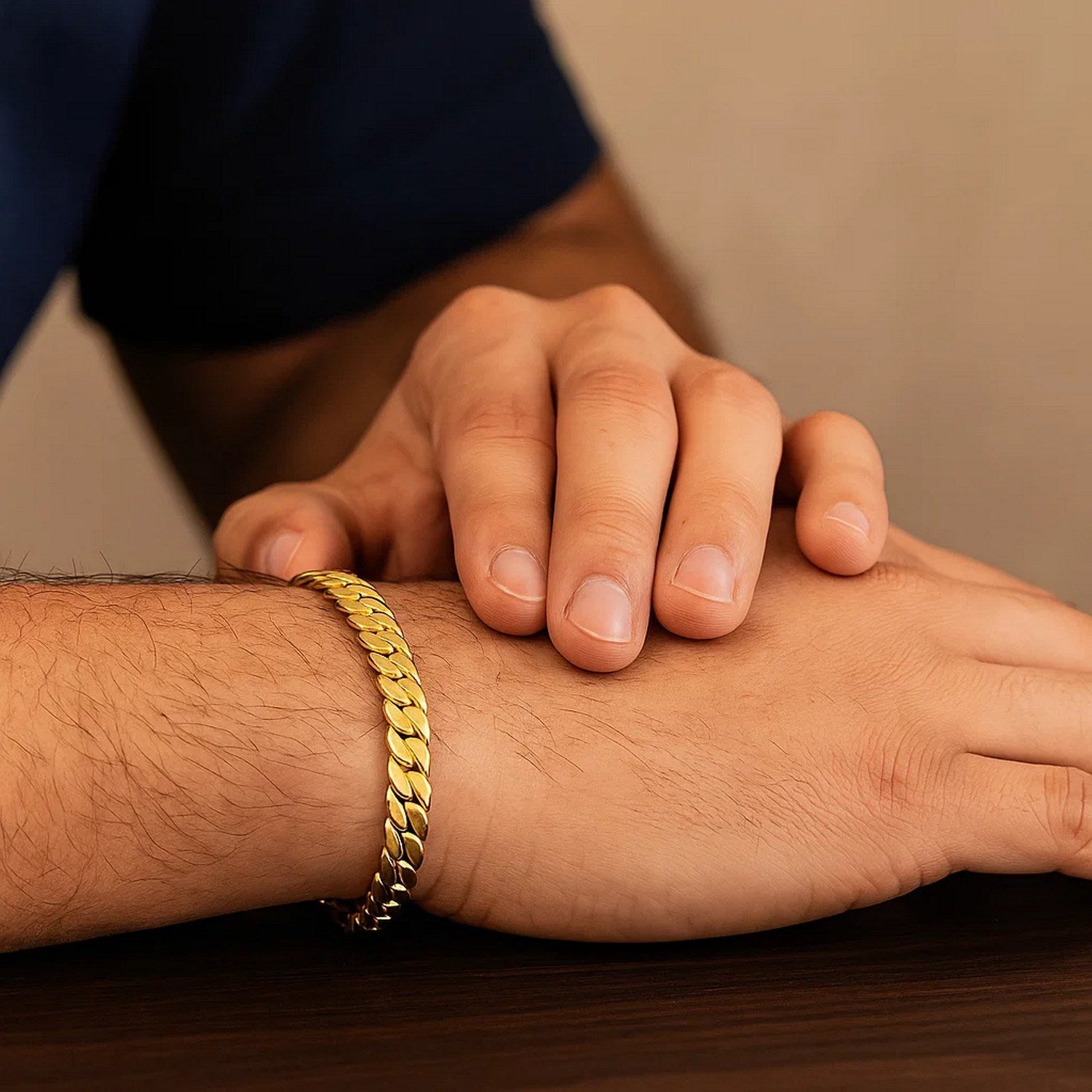 14k yellow gold curb chain bracelet on a man's wrist.