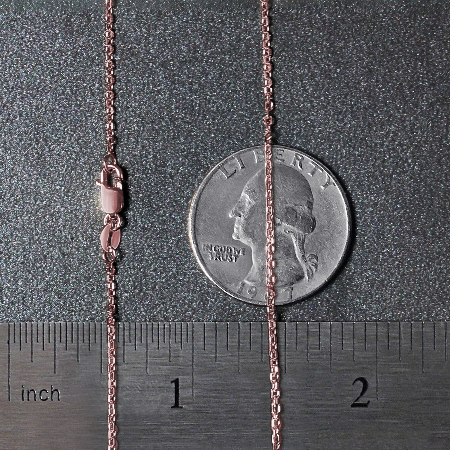 14k rose gold diamond cut cable link chain with a lobster clasp, measured against a ruler and quarter.