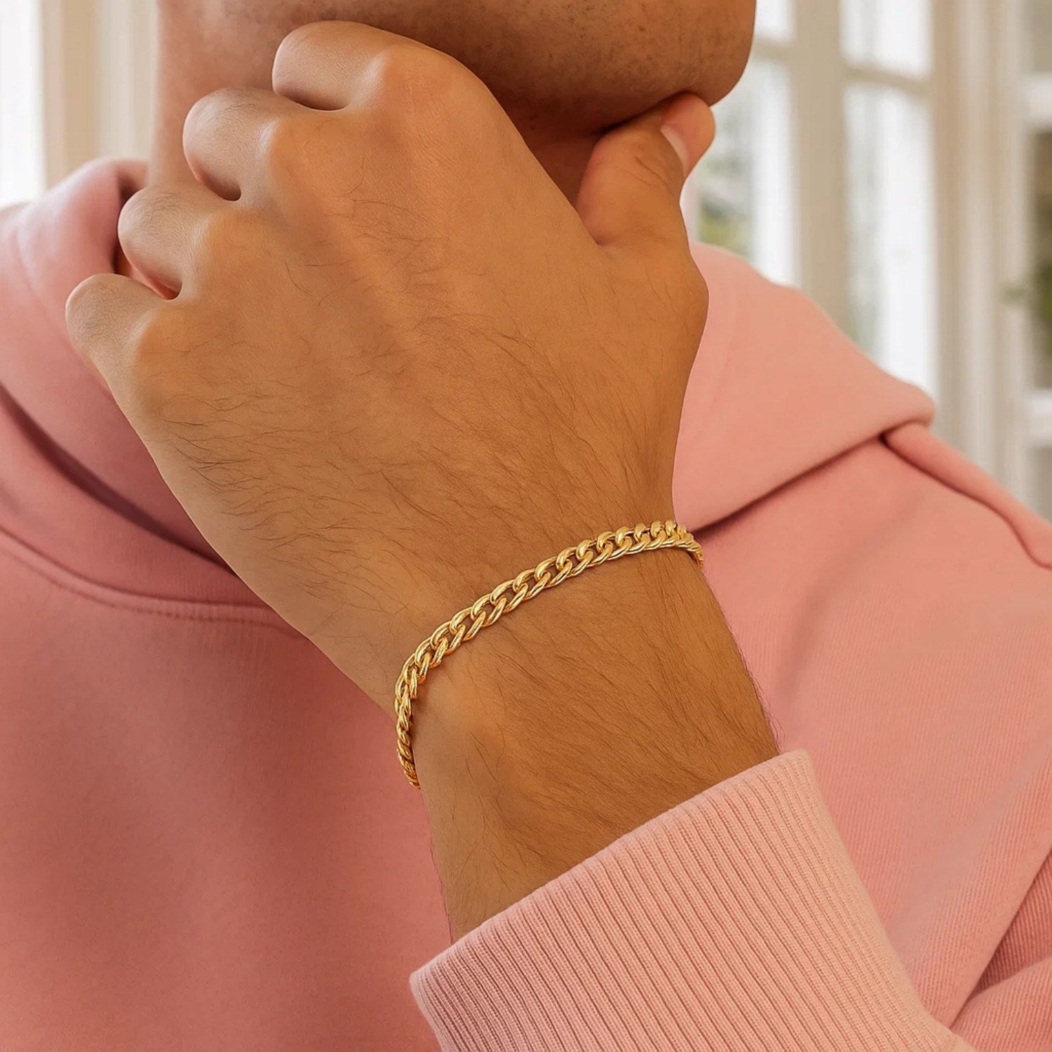 10k yellow gold Miami Cuban semi-solid bracelet on a person's wrist.