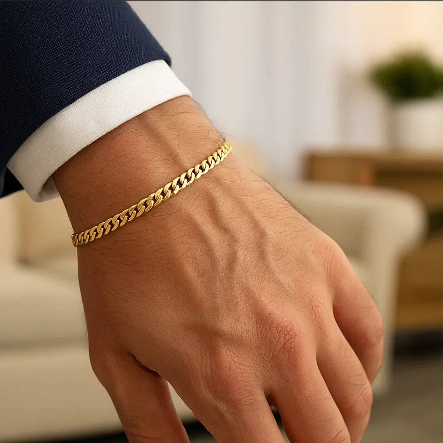 A man's wrist wearing a 10k yellow gold Miami Cuban semi-solid bracelet.