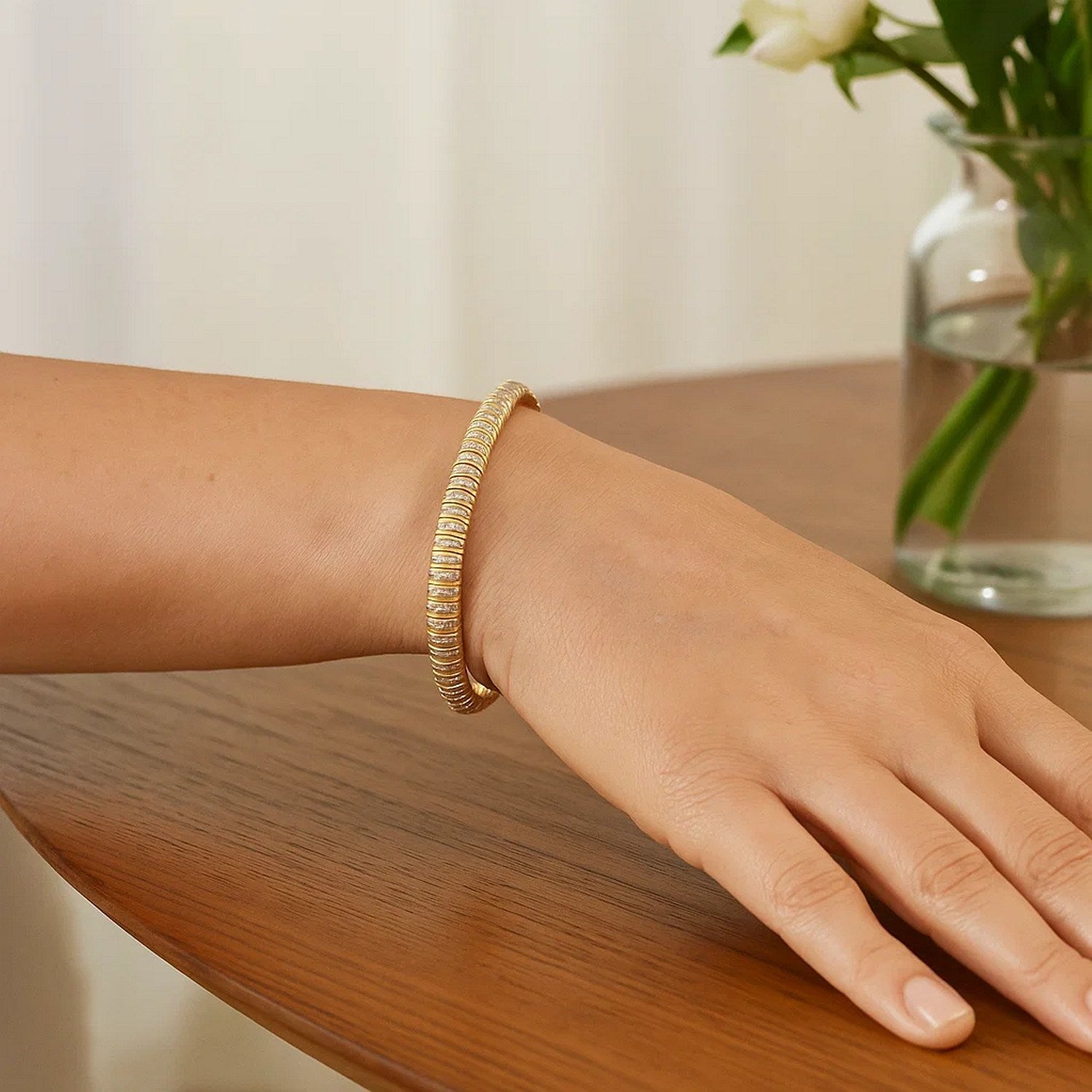 14k yellow gold diamante flex bracelet on a model's wrist.