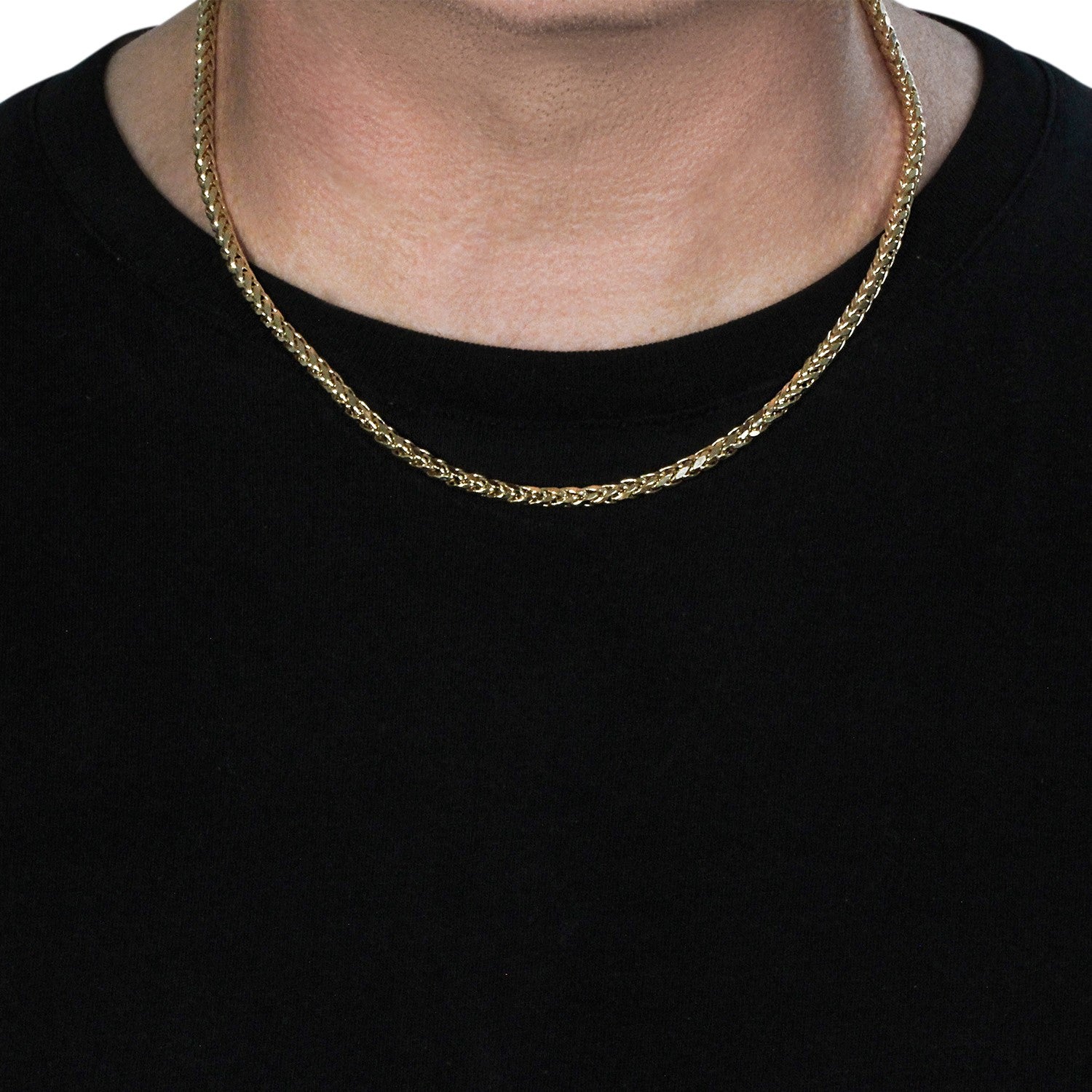 A 4.1mm 14k yellow gold diamond cut round Franco chain on a person's neck.