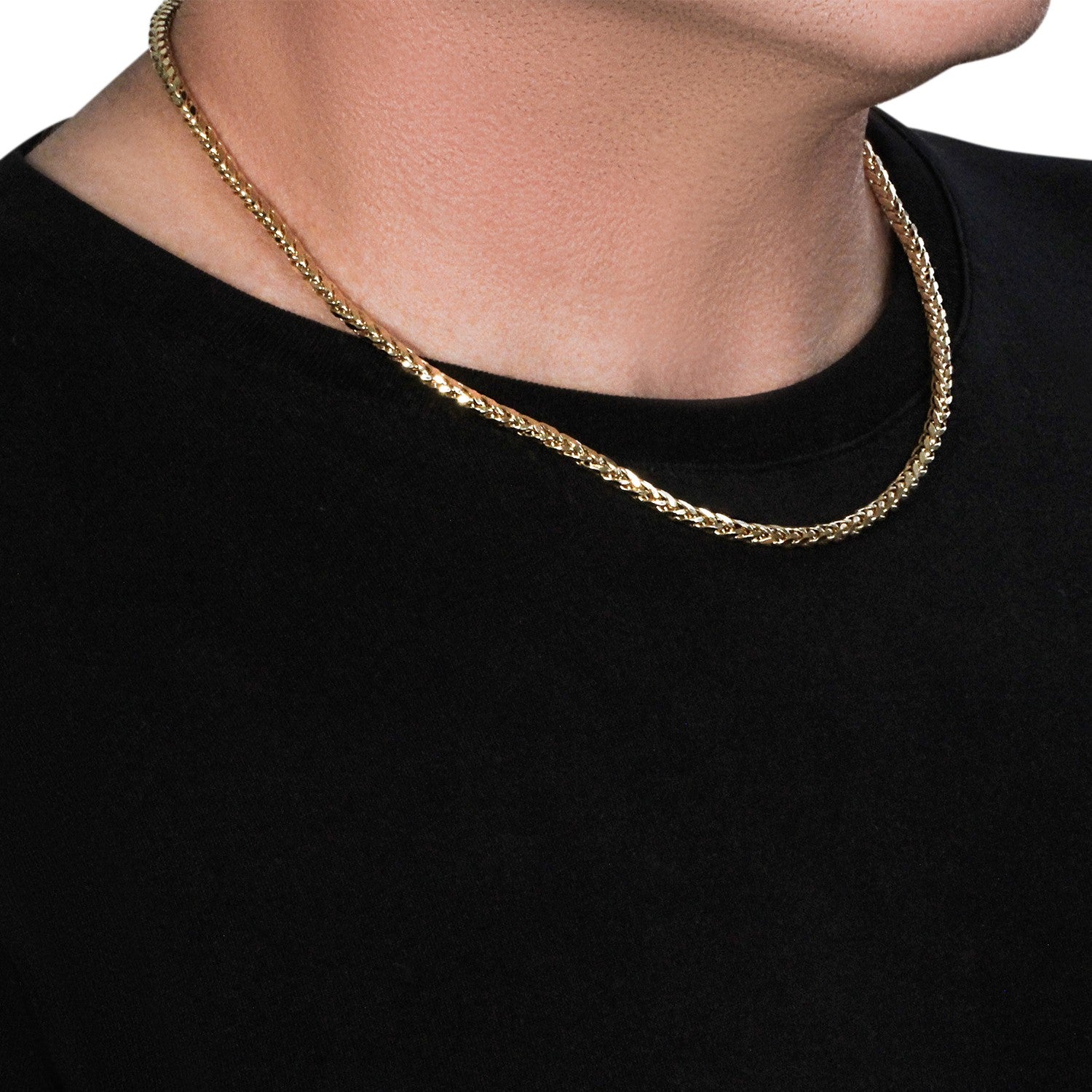 A 4.1mm 14k yellow gold diamond cut round franco chain on a person's neck.