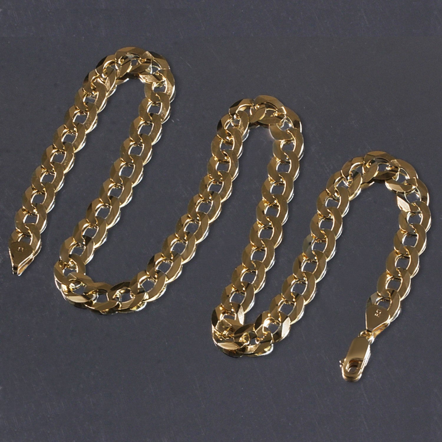 Solid 14k yellow gold curb chain, 11.23 mm wide, with a lobster clasp.