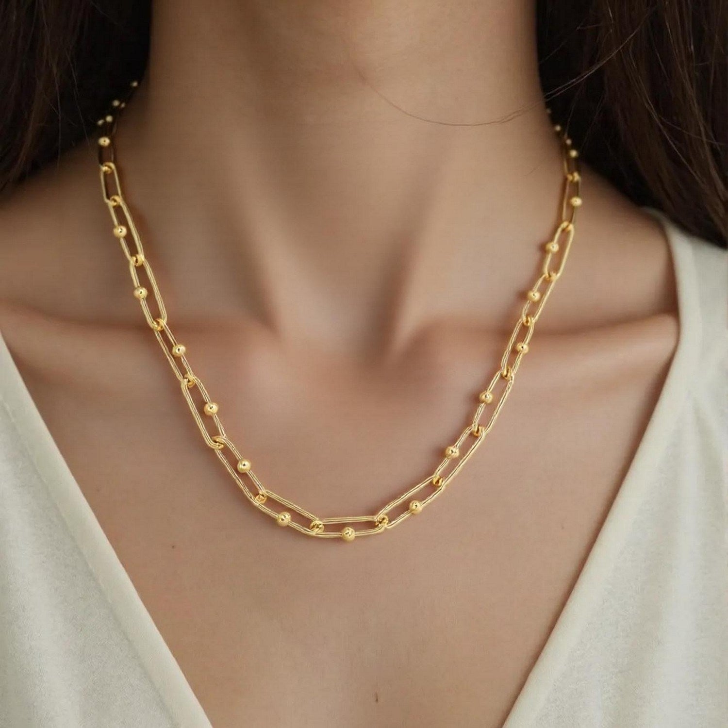 14k yellow gold high polish elongated paperclip Jax link necklace on a person.