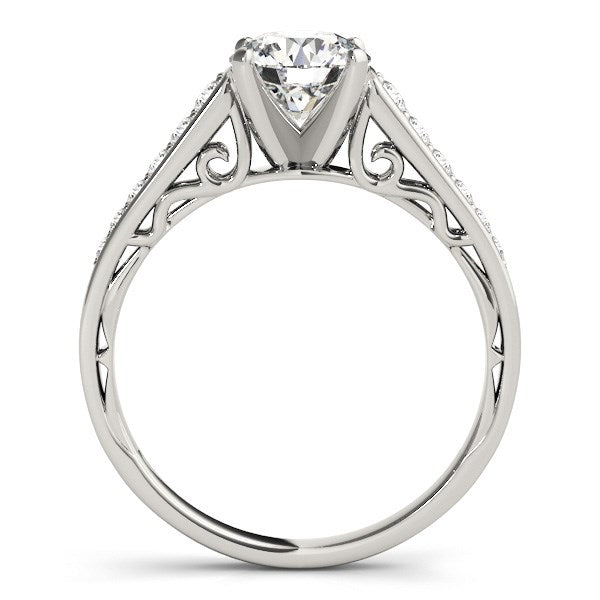 A 14k white gold cathedral diamond engagement ring with intricate filigree and pavé diamonds.