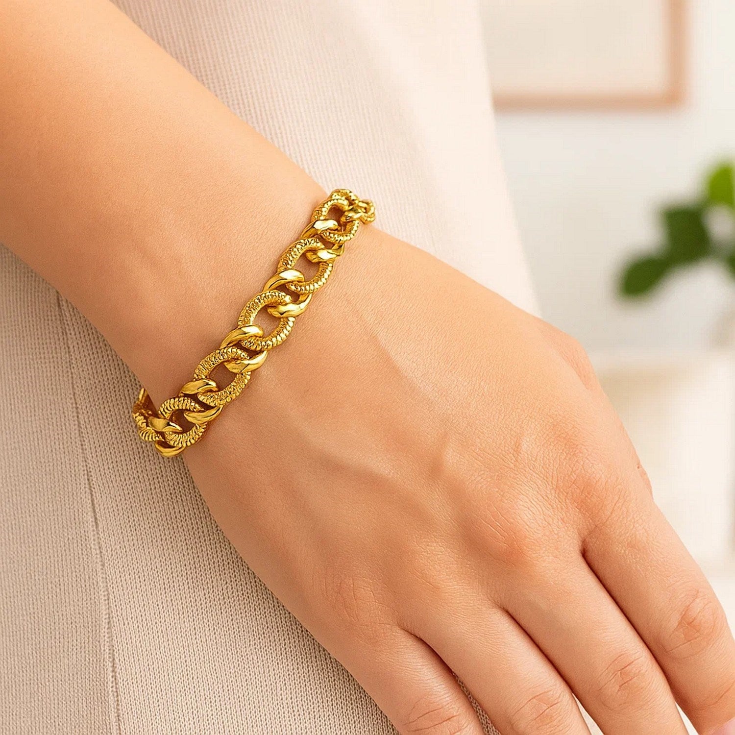 14k yellow gold curb chain bracelet with diamond cuts on a person's wrist.