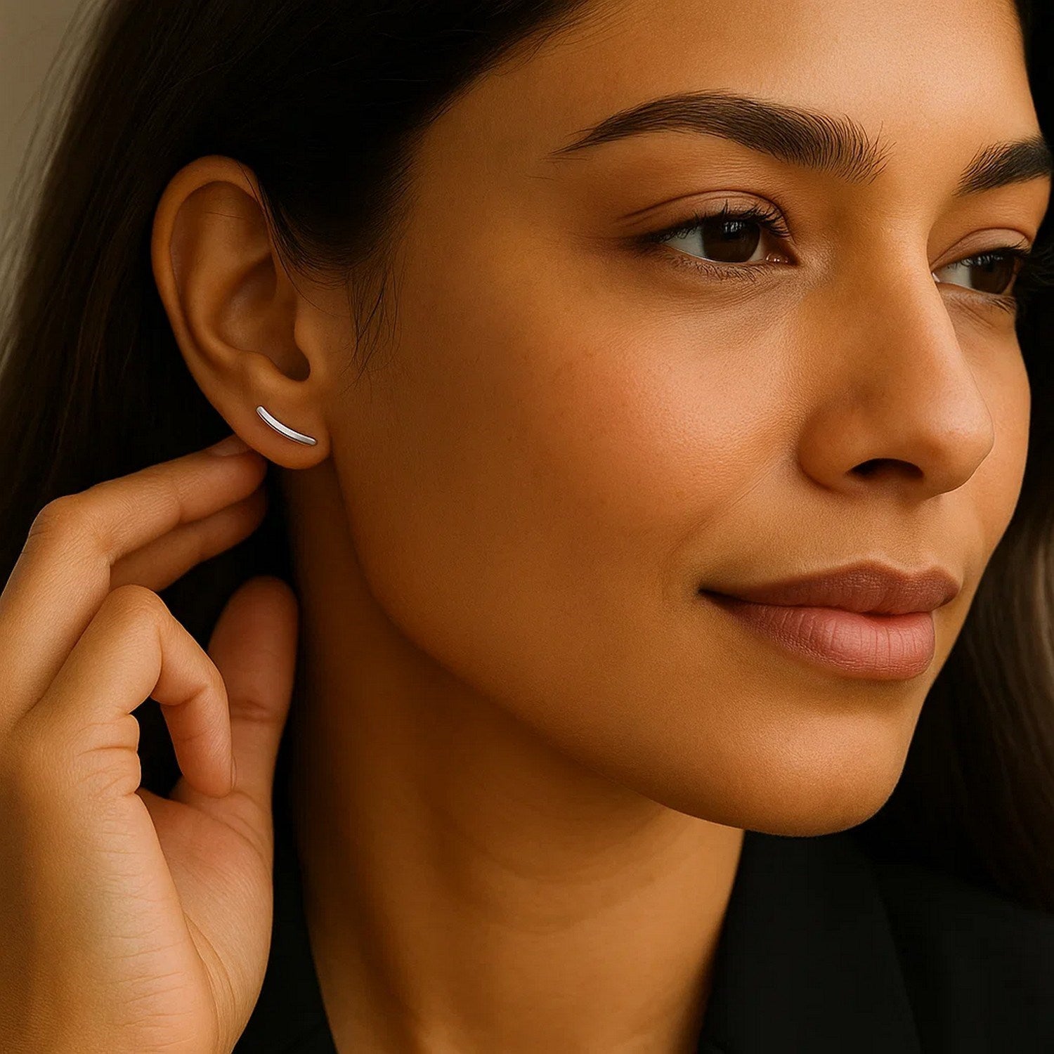 14k white gold curve climber post earrings on a woman's ear.