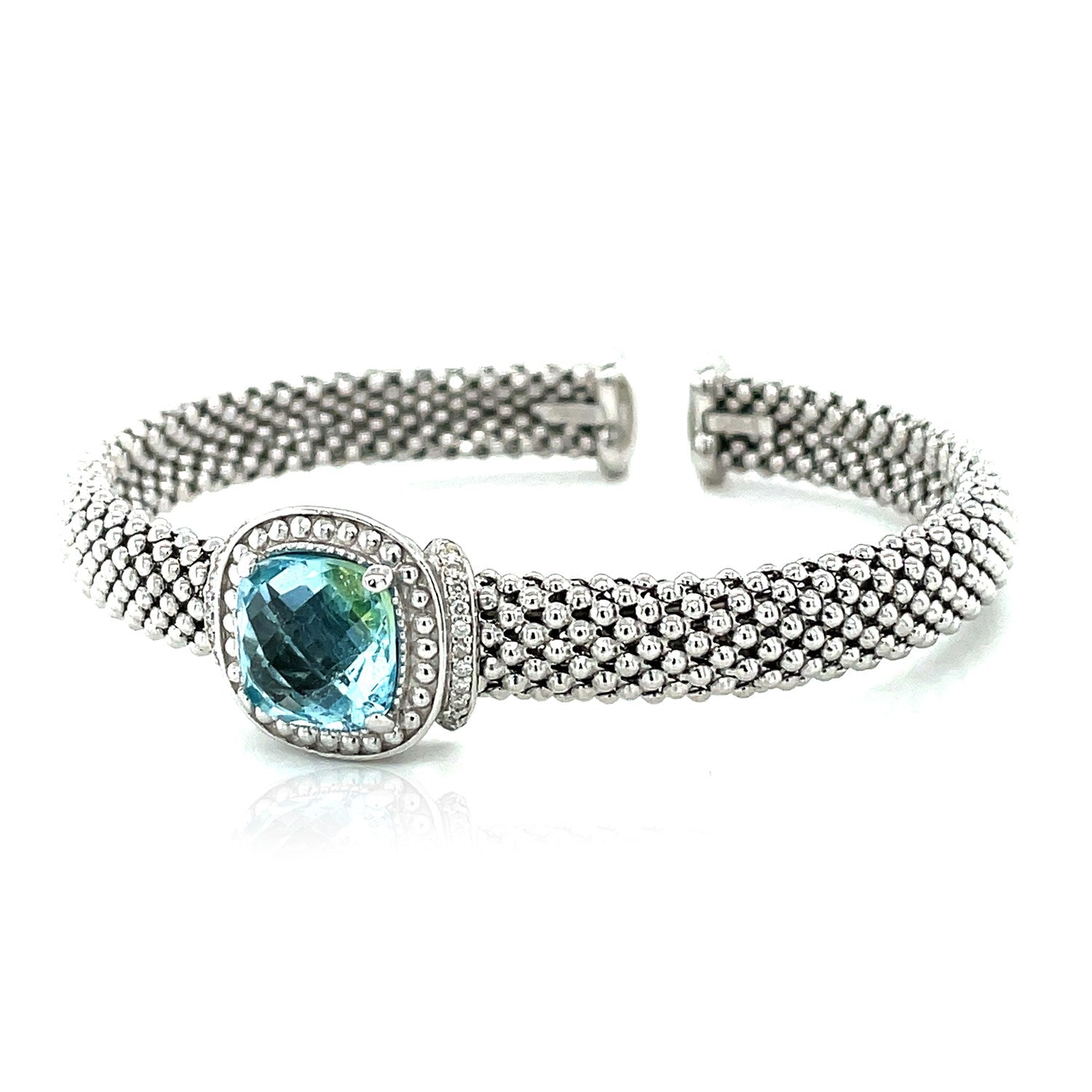 Sterling silver popcorn texture cuff bangle with a cushion-cut blue topaz and diamonds.