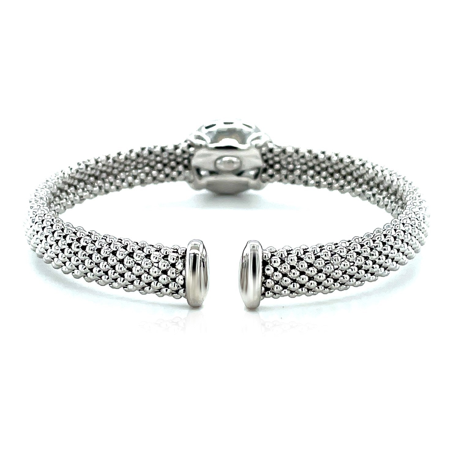 Sterling silver popcorn texture cuff bangle with a blue topaz and diamonds.