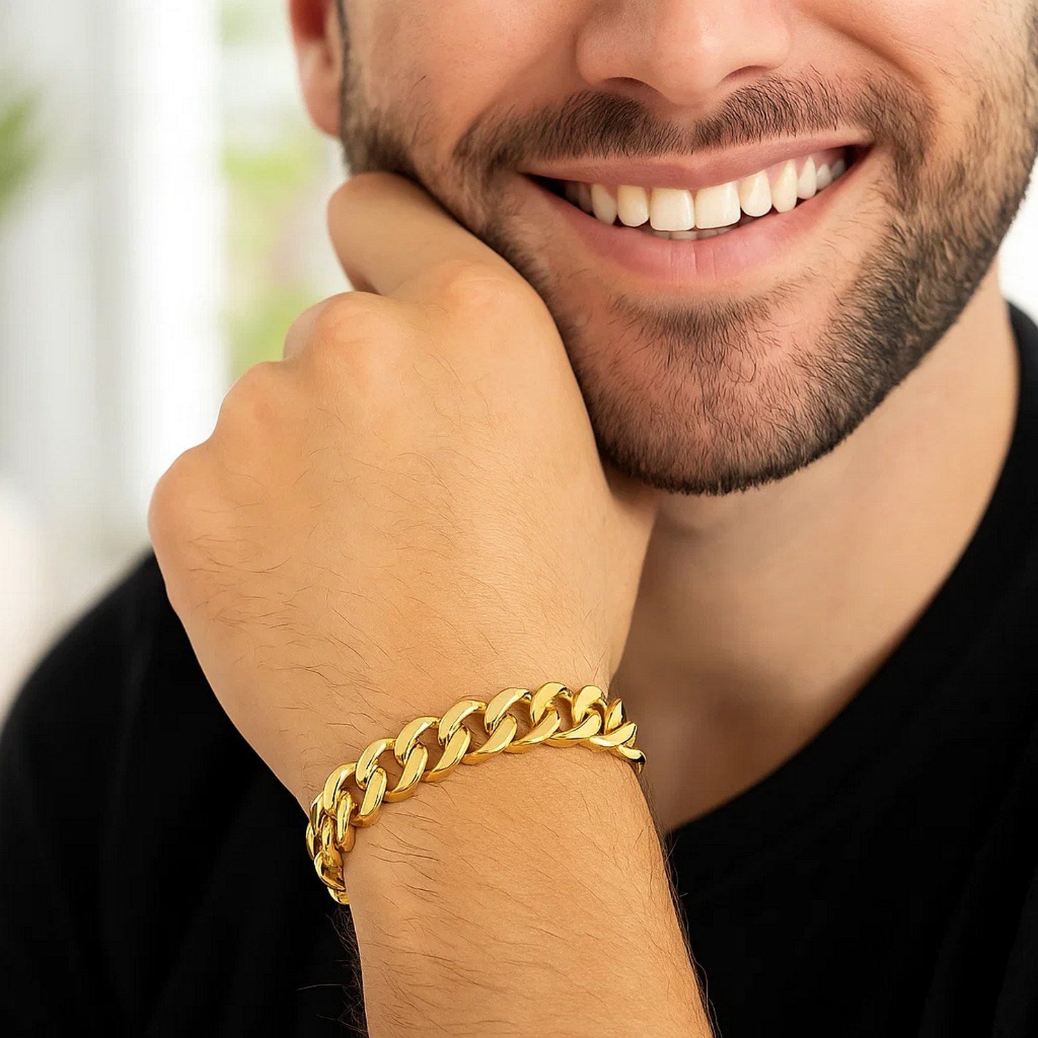 14k yellow gold polished curb chain bracelet on a man's wrist.