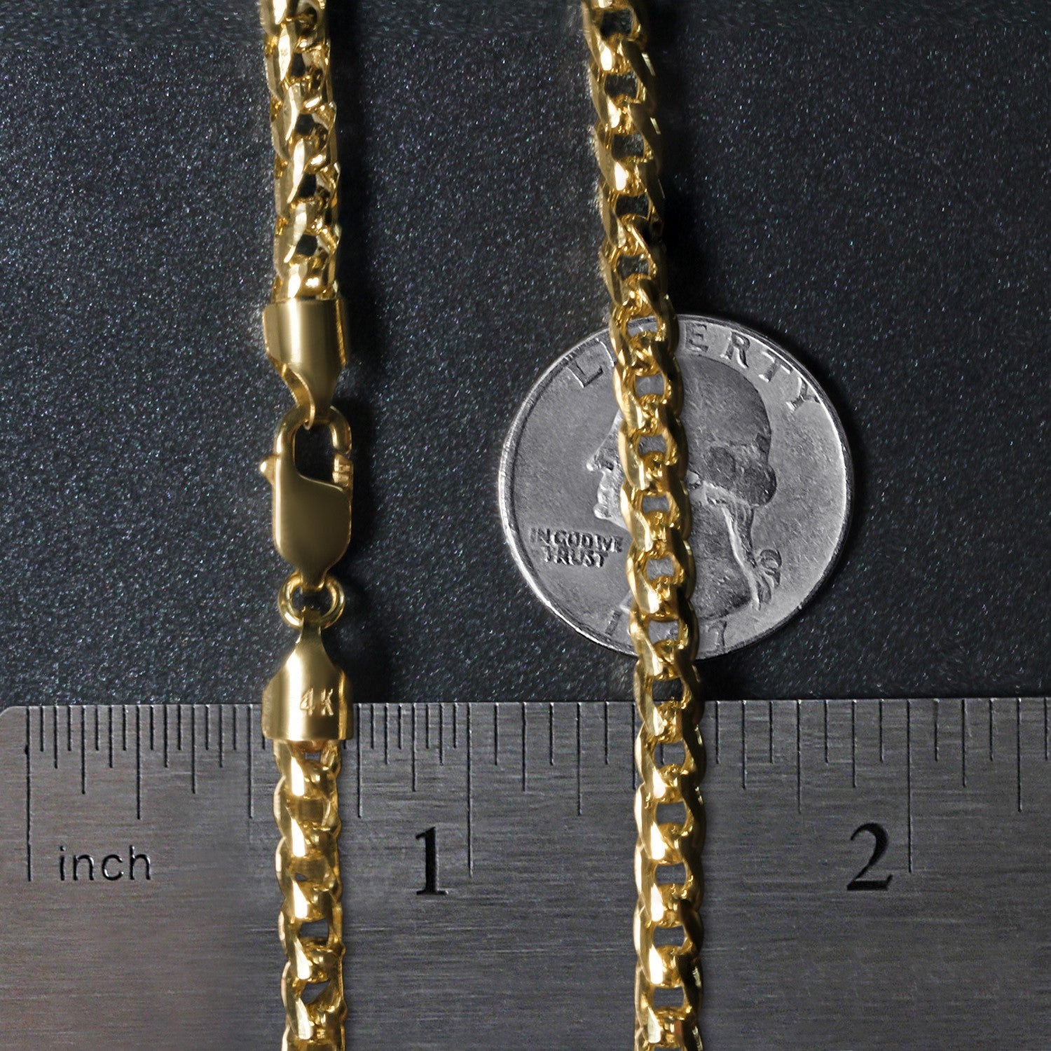 A 14k yellow gold diamond-cut round Franco chain with a lobster clasp, shown next to a ruler and a quarter for scale.