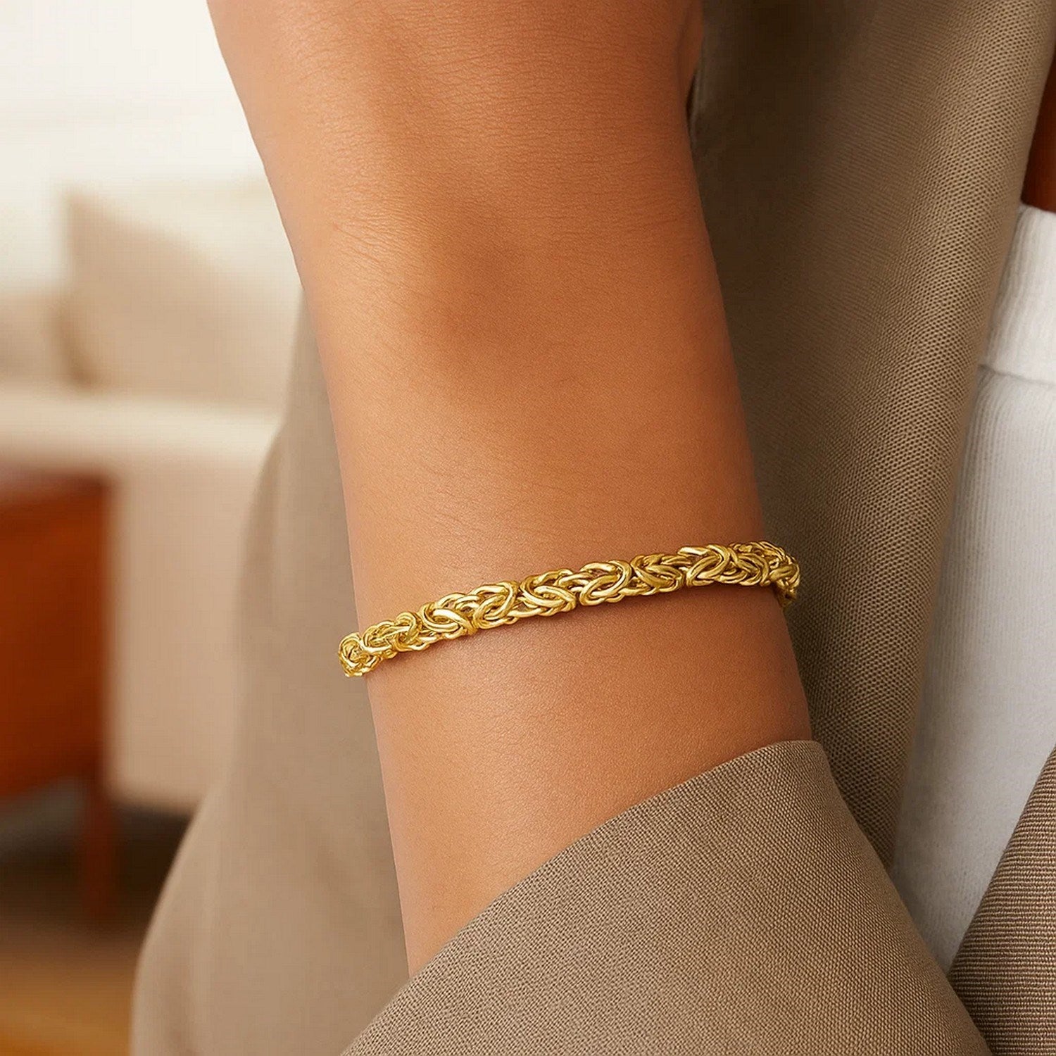 14k yellow gold Byzantine link bracelet on a person's arm.