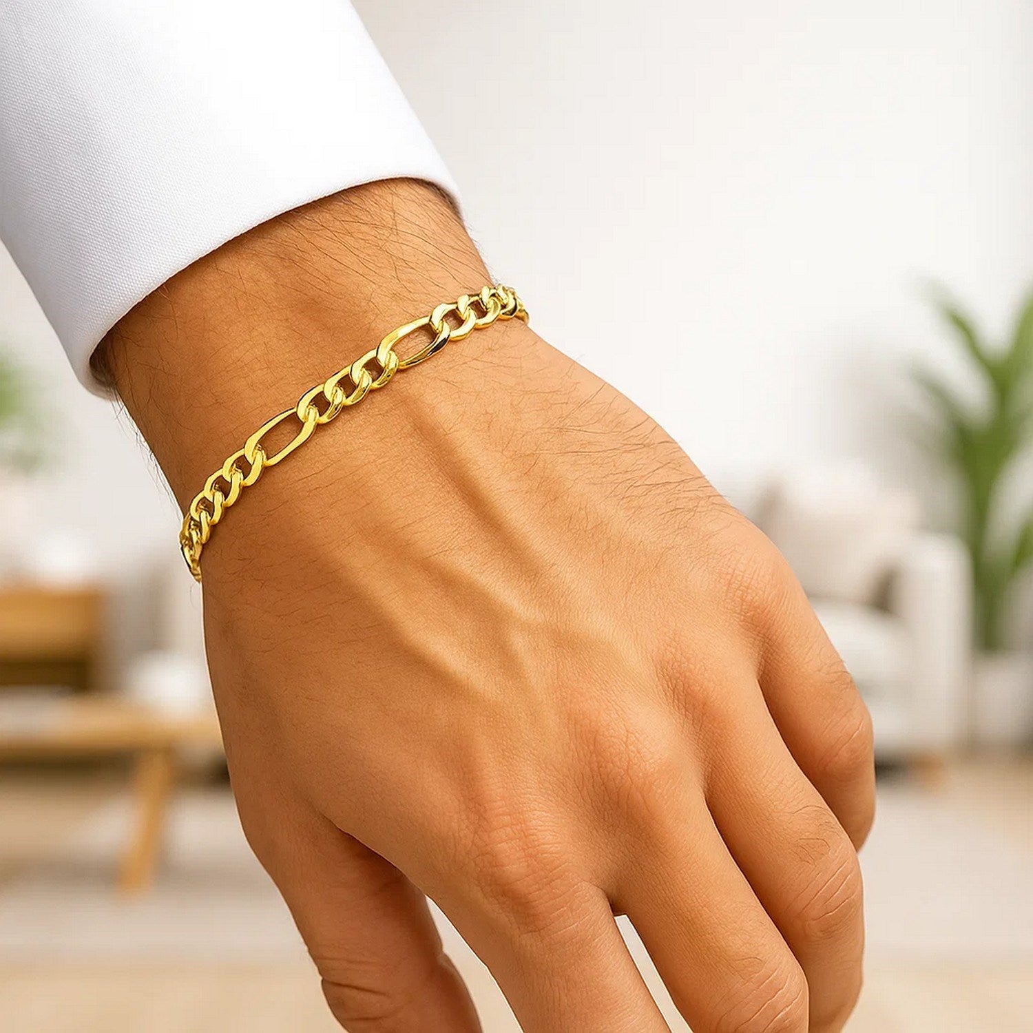 10k yellow gold lite Figaro bracelet on a person's wrist.