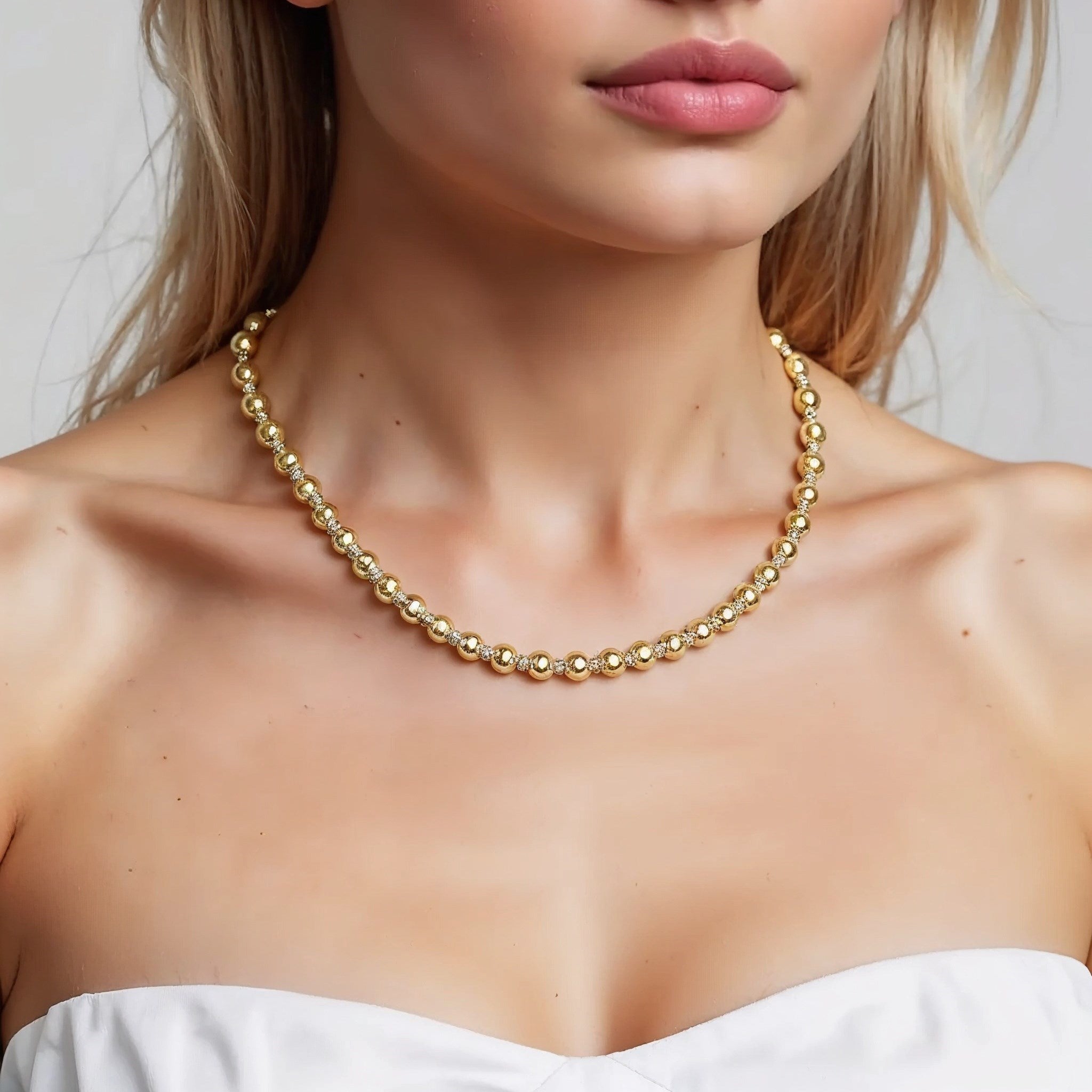 Two Tone Beaded Chain Necklace in 14K Gold on a woman's neck.