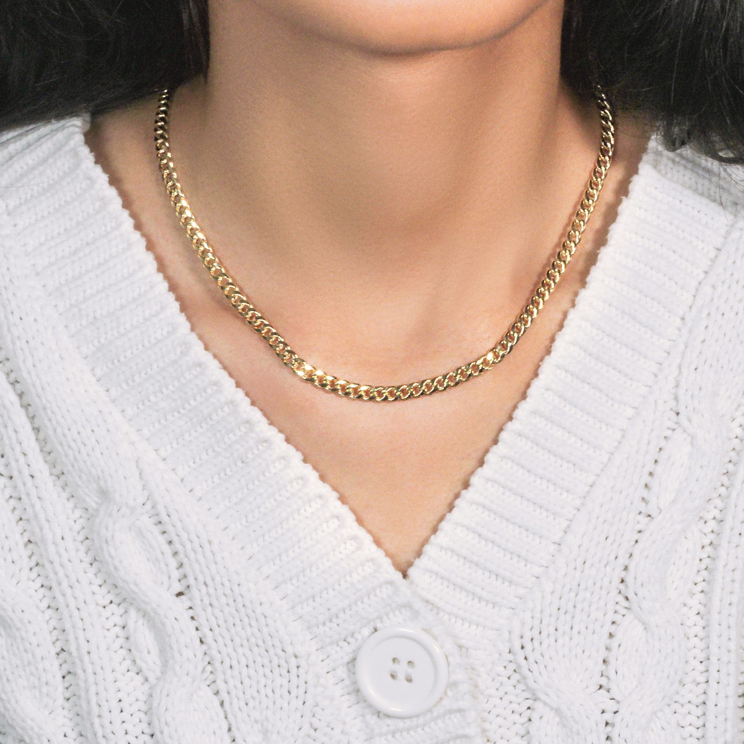A 10k yellow gold Miami Cuban semi-solid chain, 4.50 mm wide, worn around a neck.