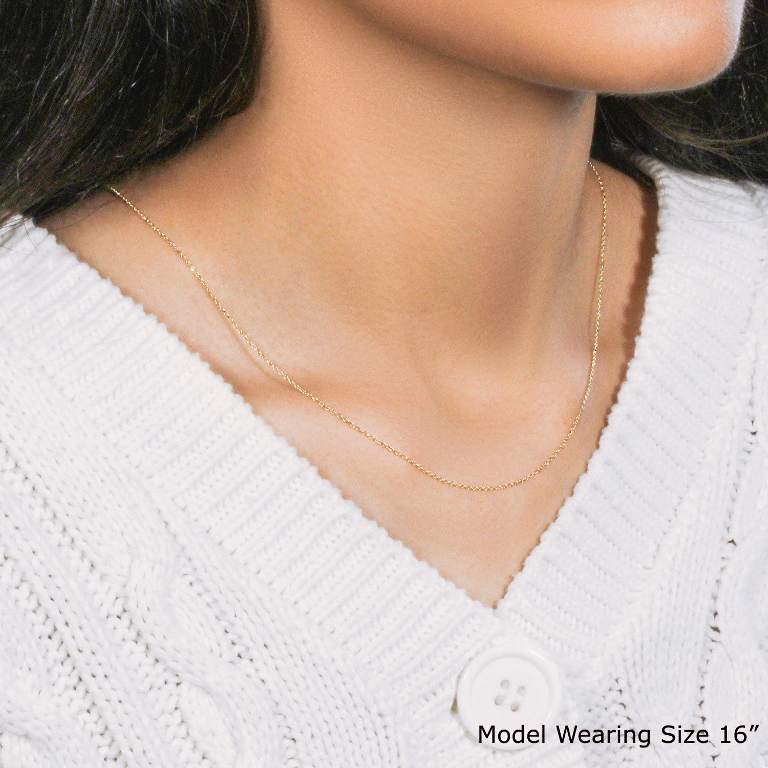 A 10k yellow gold diamond cut cable link chain (0.87 mm) on a model.