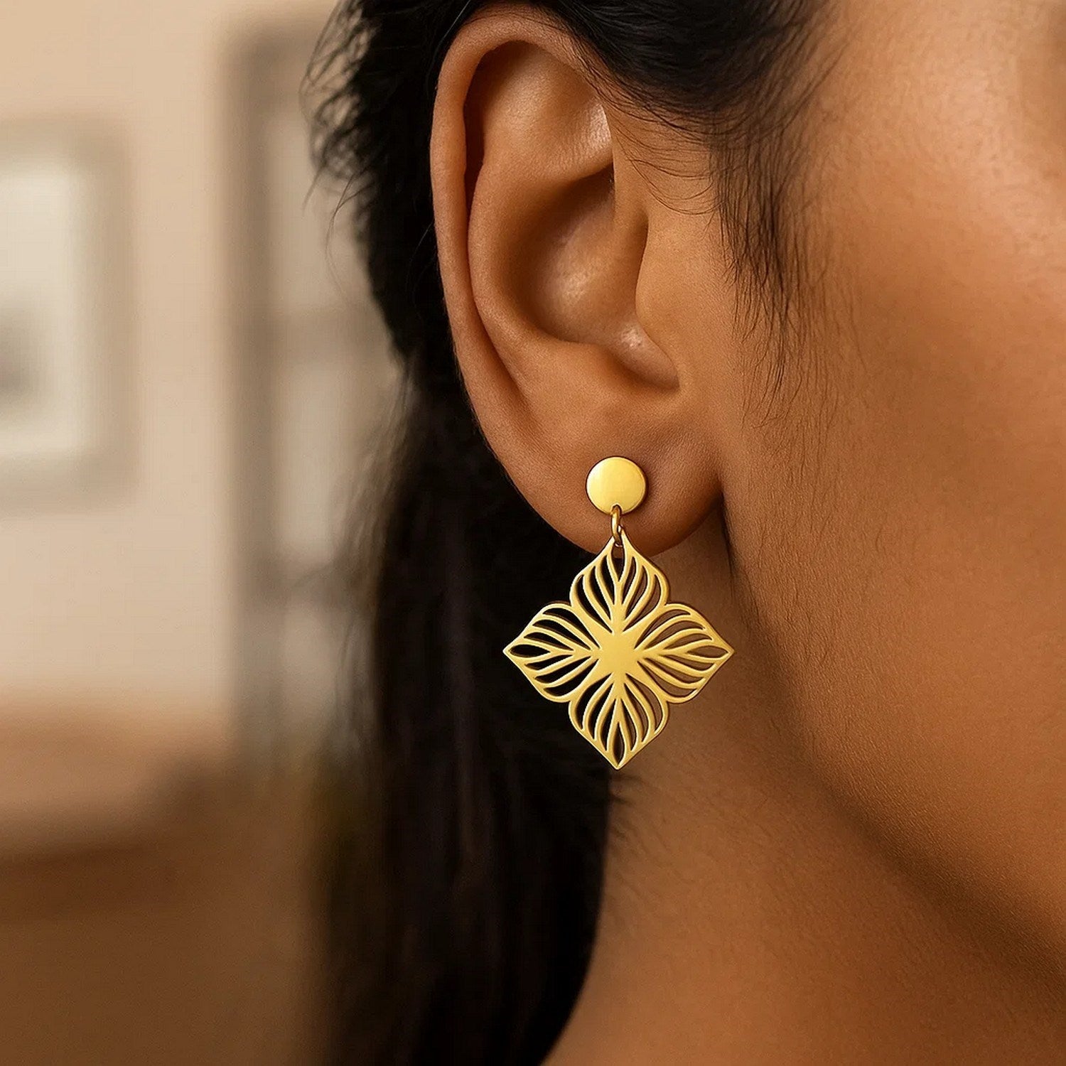 14K yellow gold flower cutout dangle earrings with a high polish finish.