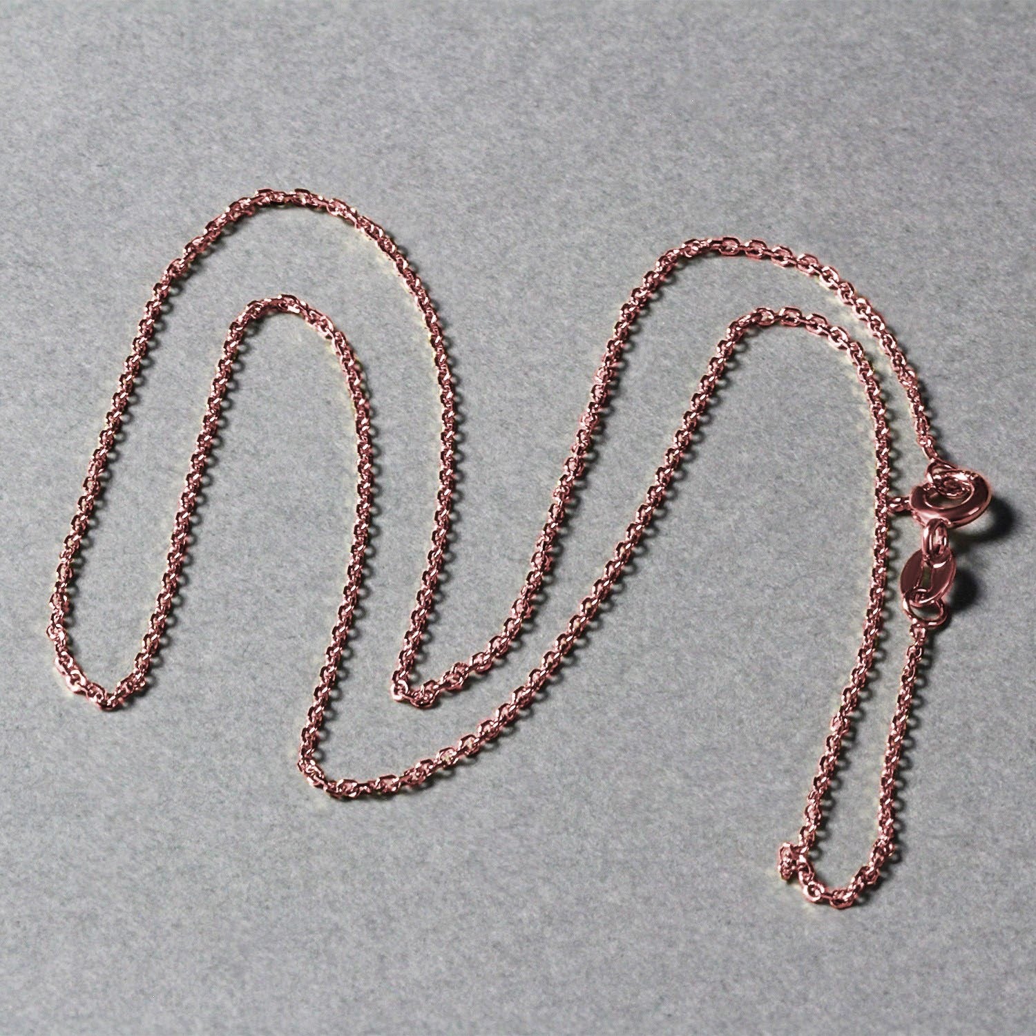 18k rose gold diamond cut cable link chain with a spring ring clasp.