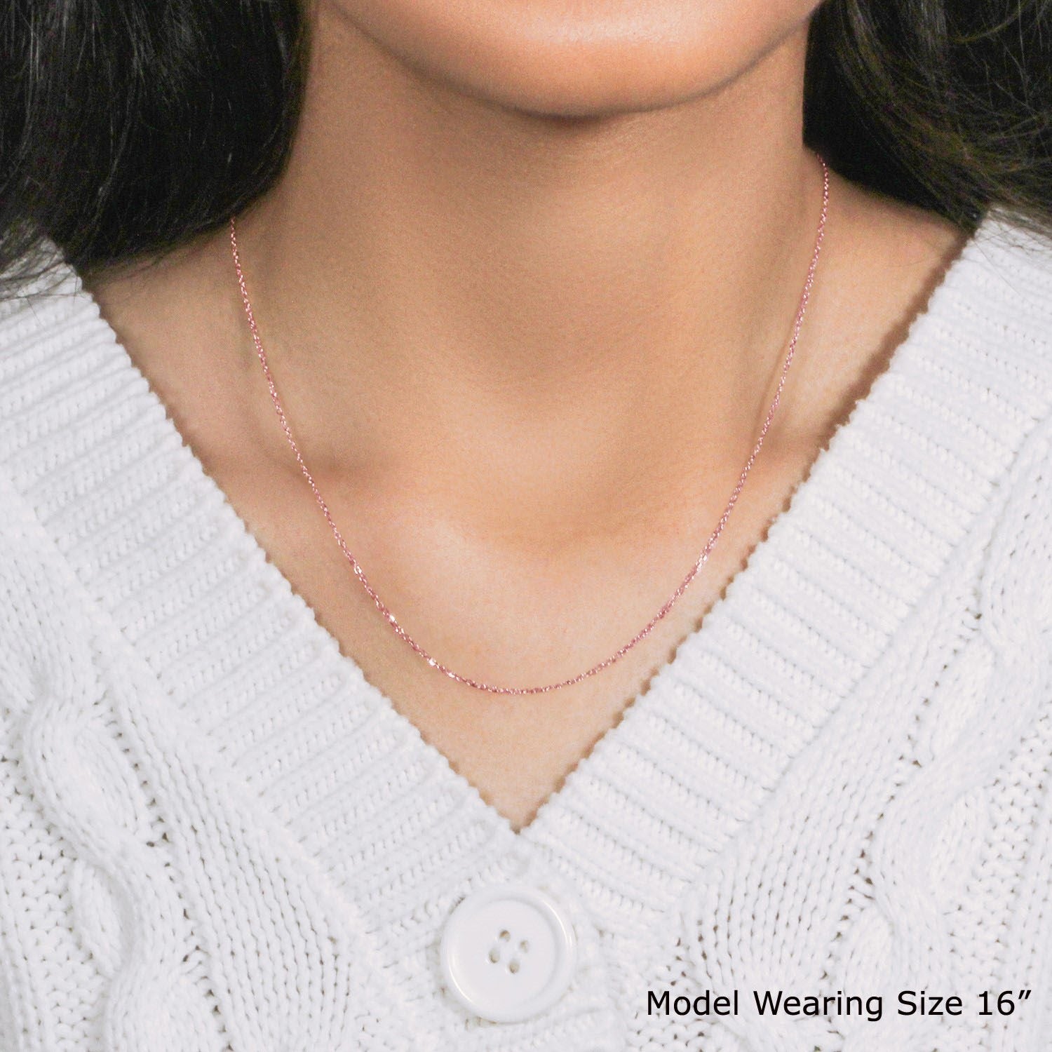 18k rose gold diamond cut cable link chain on a model.