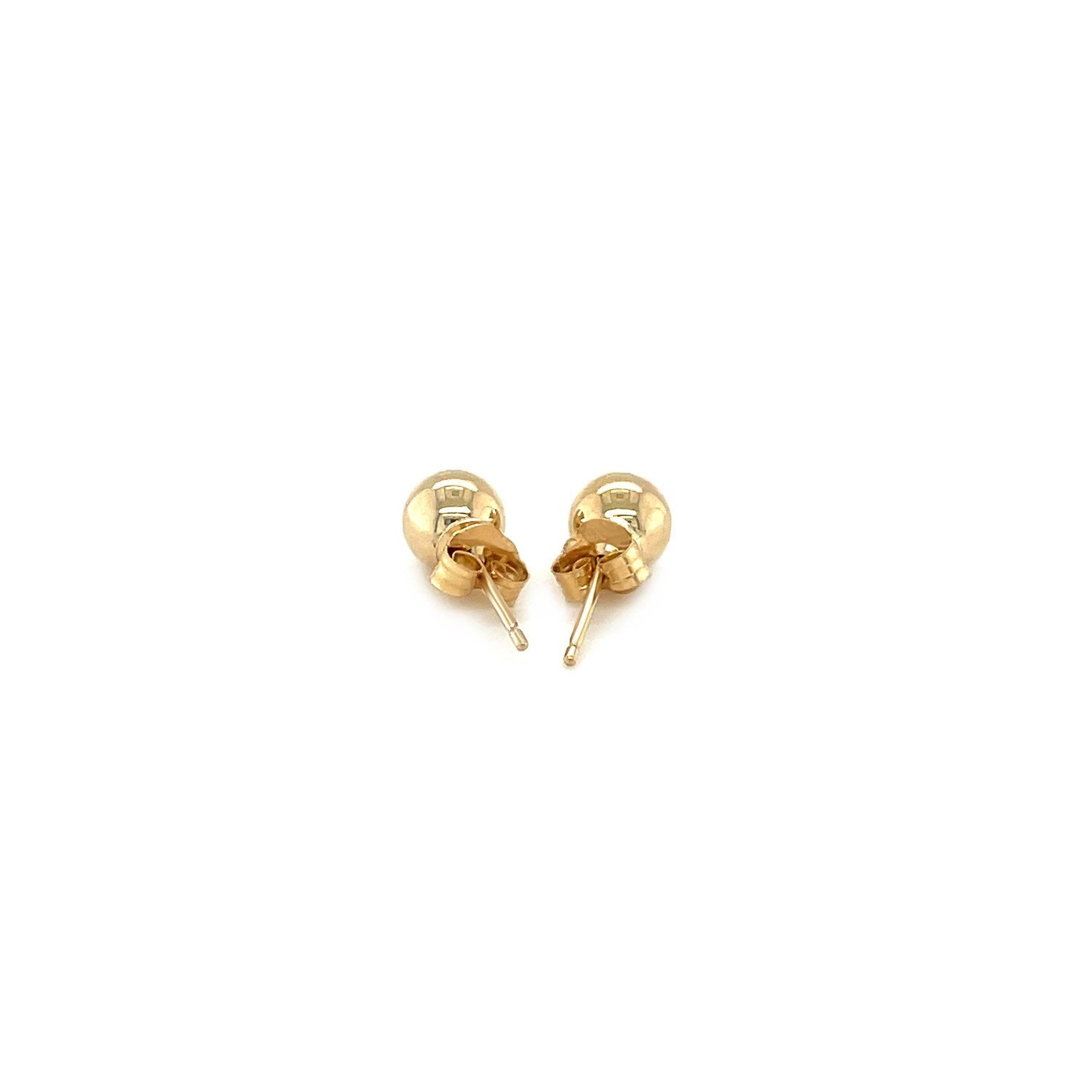 A pair of 10k yellow gold round stud earrings with push backs.