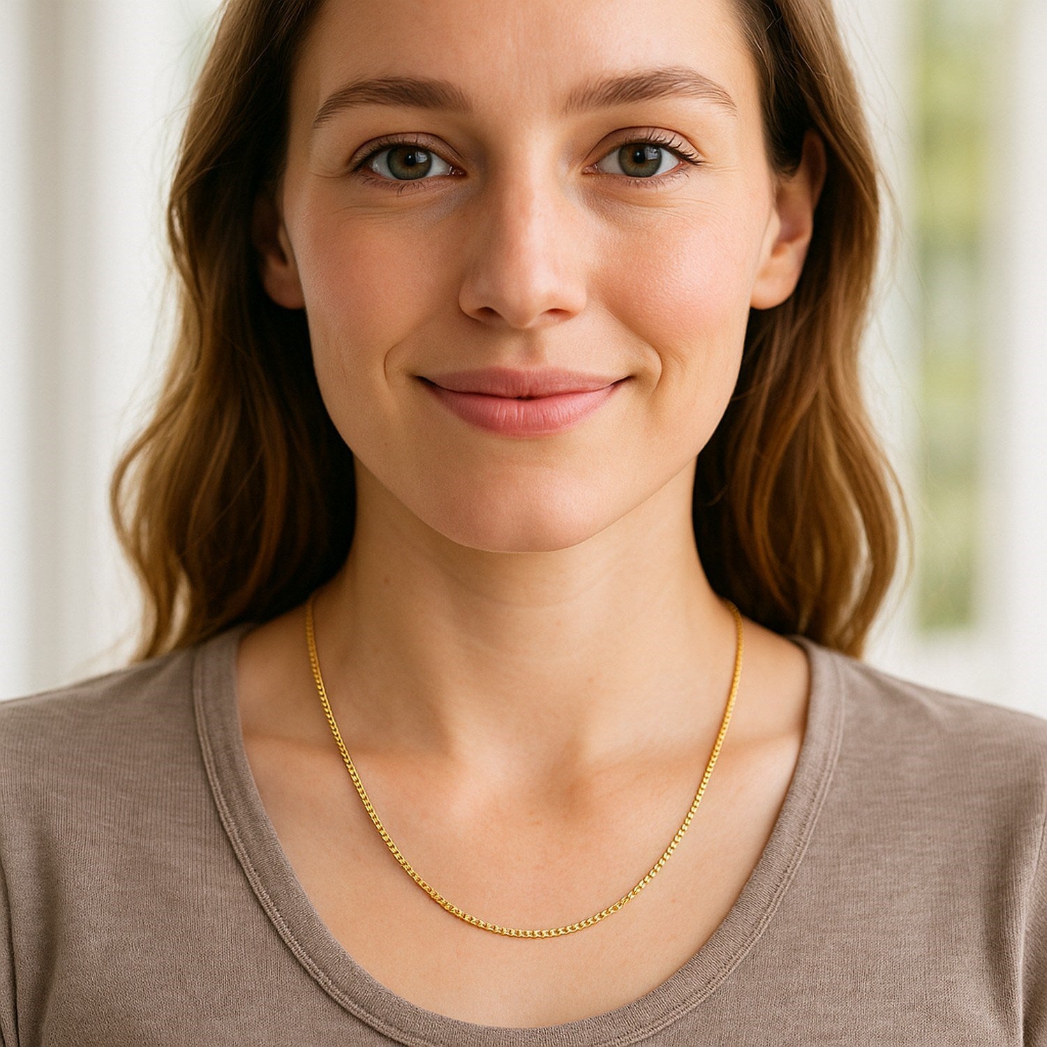 A woman wears a 10k yellow gold classic box chain.