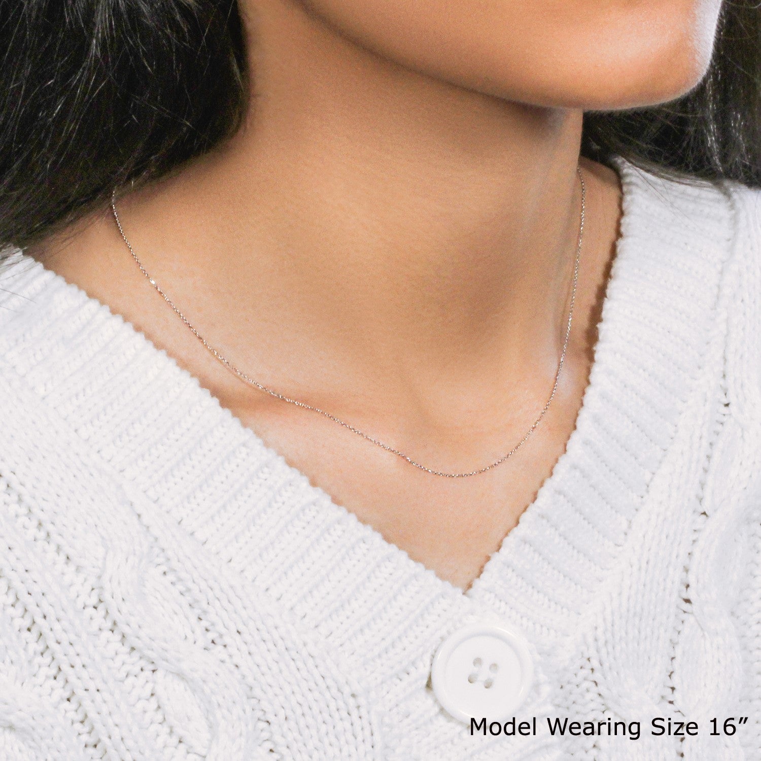 A 14k white gold diamond-cut cable link chain, 0.68 mm wide, worn by a model.