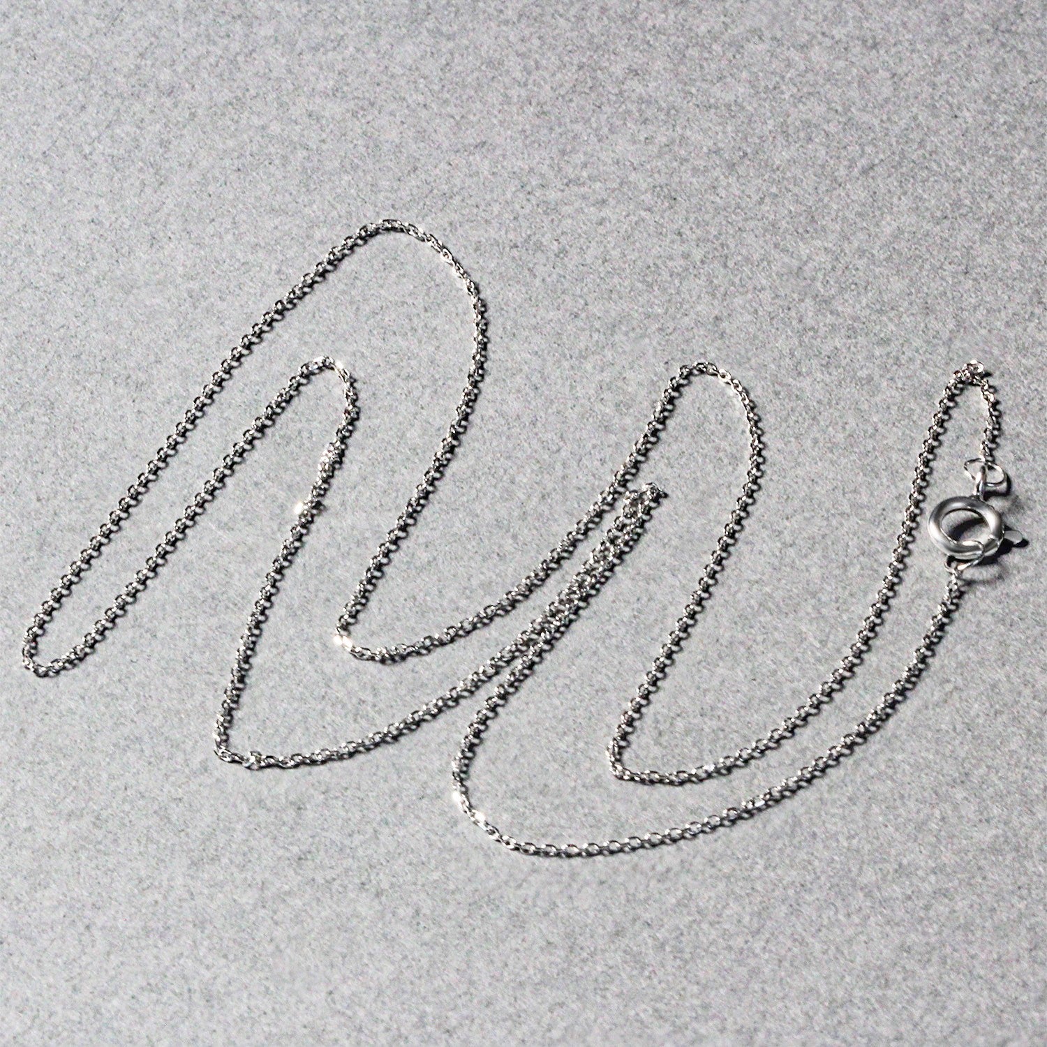 14k white gold diamond cut cable link chain with a spring ring clasp.