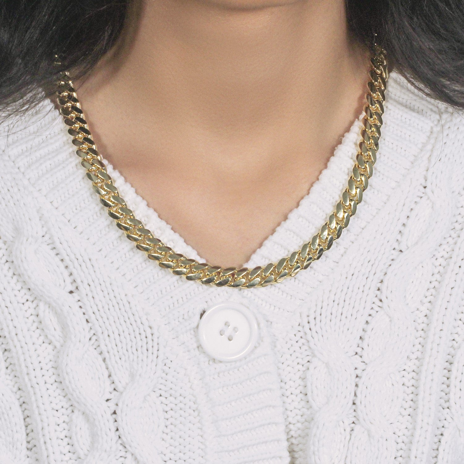 14k yellow gold classic Miami Cuban solid chain (9.20 mm) on a person wearing a white sweater.