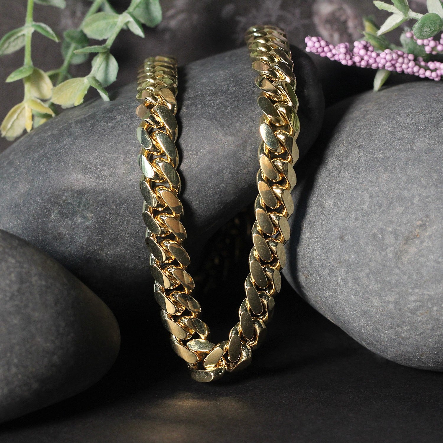 14k yellow gold classic Miami Cuban solid chain, 9.20 mm wide, on dark rocks.
