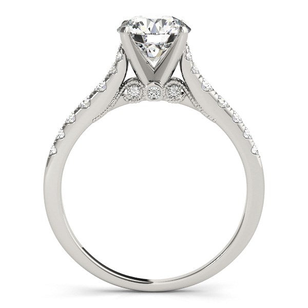 14k white gold engagement ring with a round diamond and pavé band.