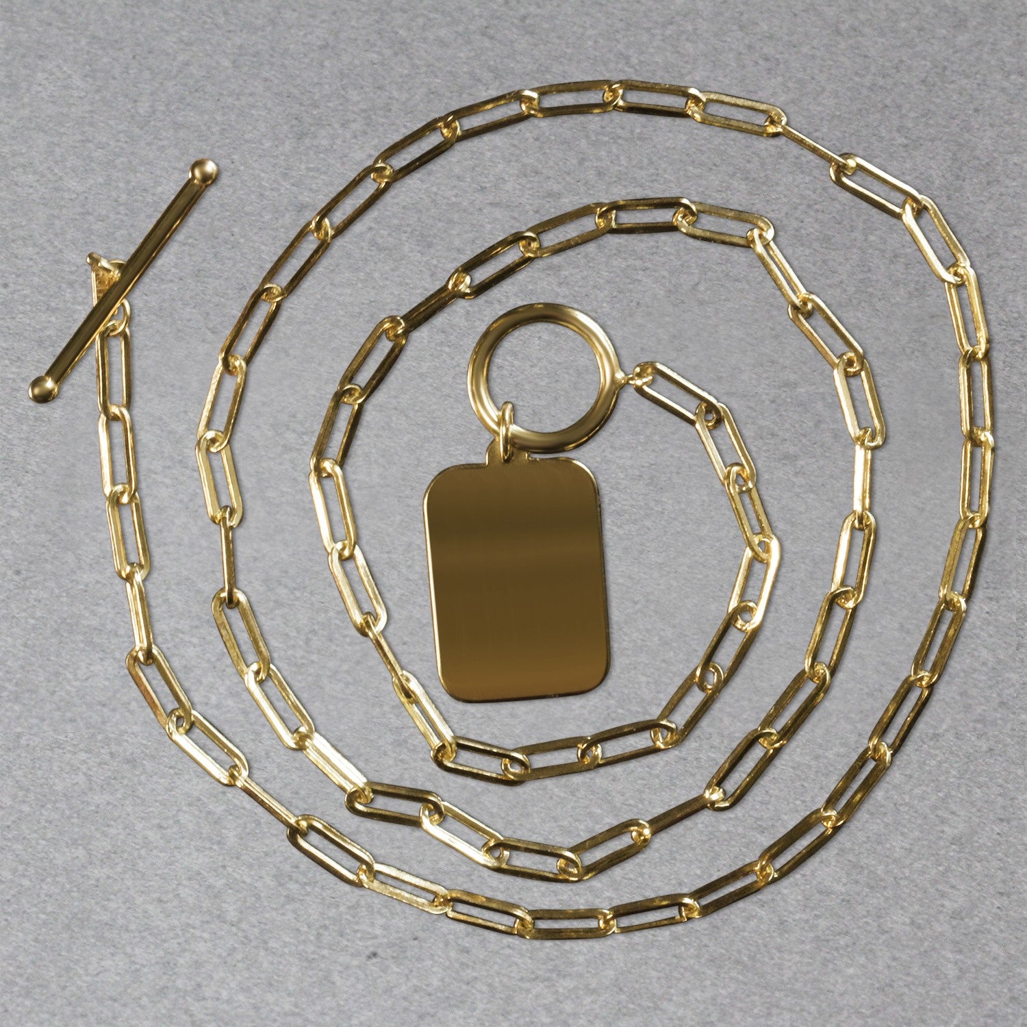 14k yellow gold paperclip chain necklace with a rounded rectangle pendant and toggle clasp.