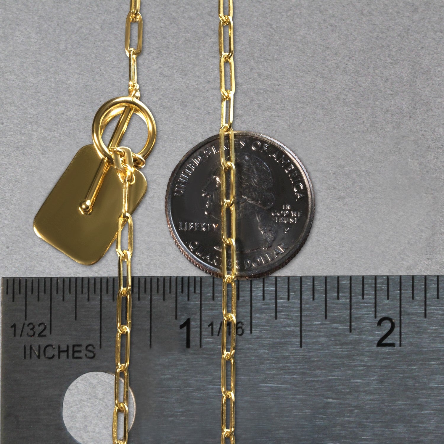 14k yellow gold paperclip chain necklace with a rounded rectangle pendant and toggle clasp.