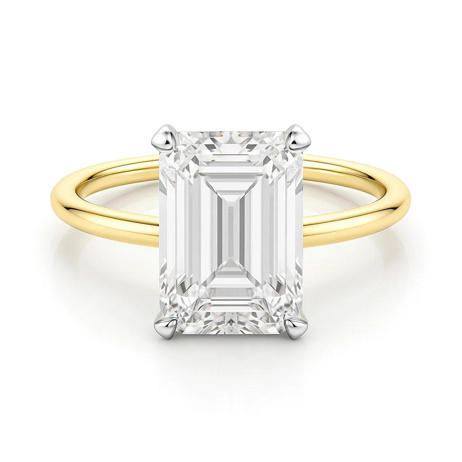 An emerald-cut lab-grown diamond solitaire ring with white gold prongs on a yellow gold band.